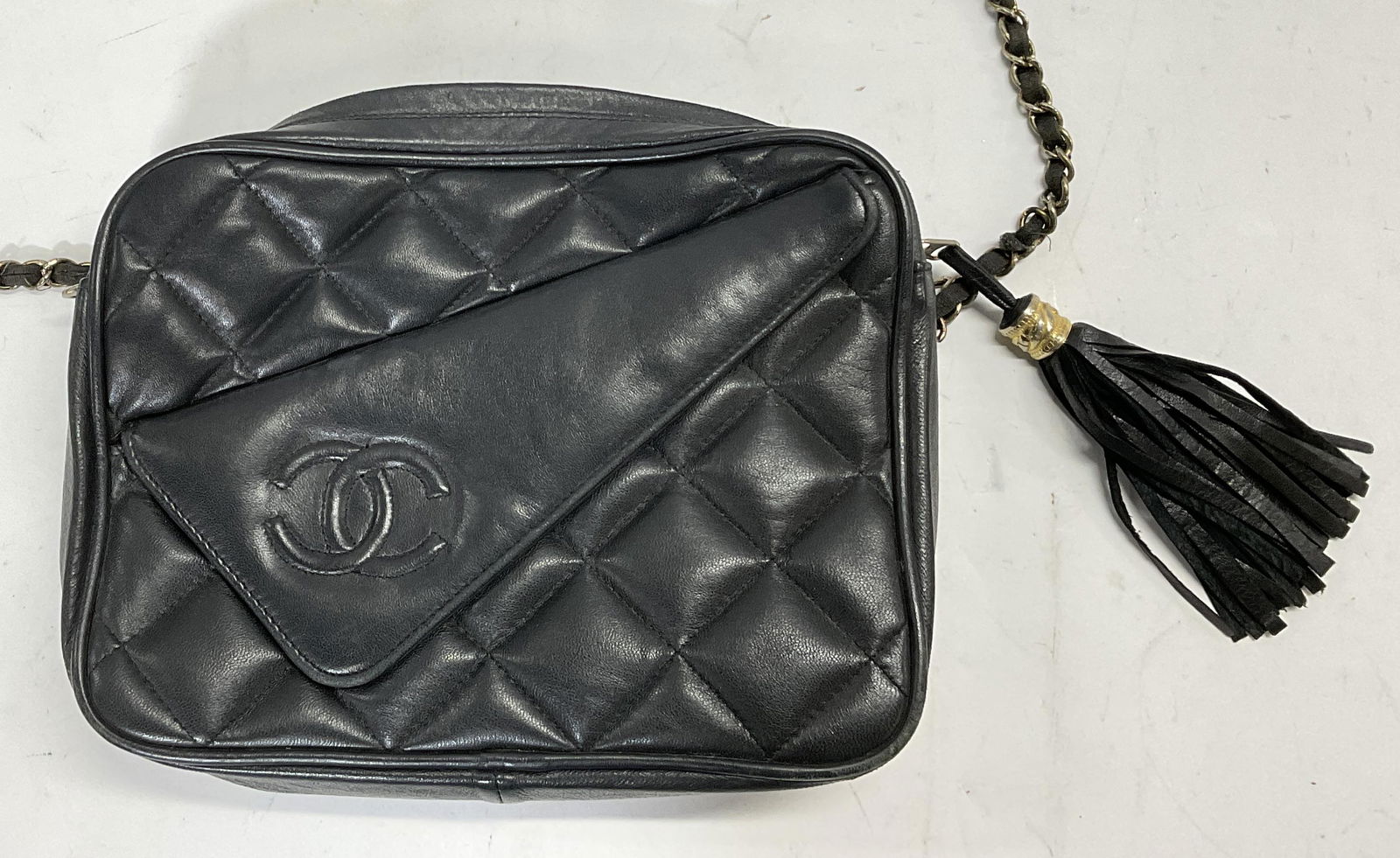 CHANEL Style Purse: Chanel style purse. Not authenticated. Gold accents to tassel and chain. Red interior to bag, functional zippers. Shoulder strap only attached to one end of purse. Significant wear to some parts of pi