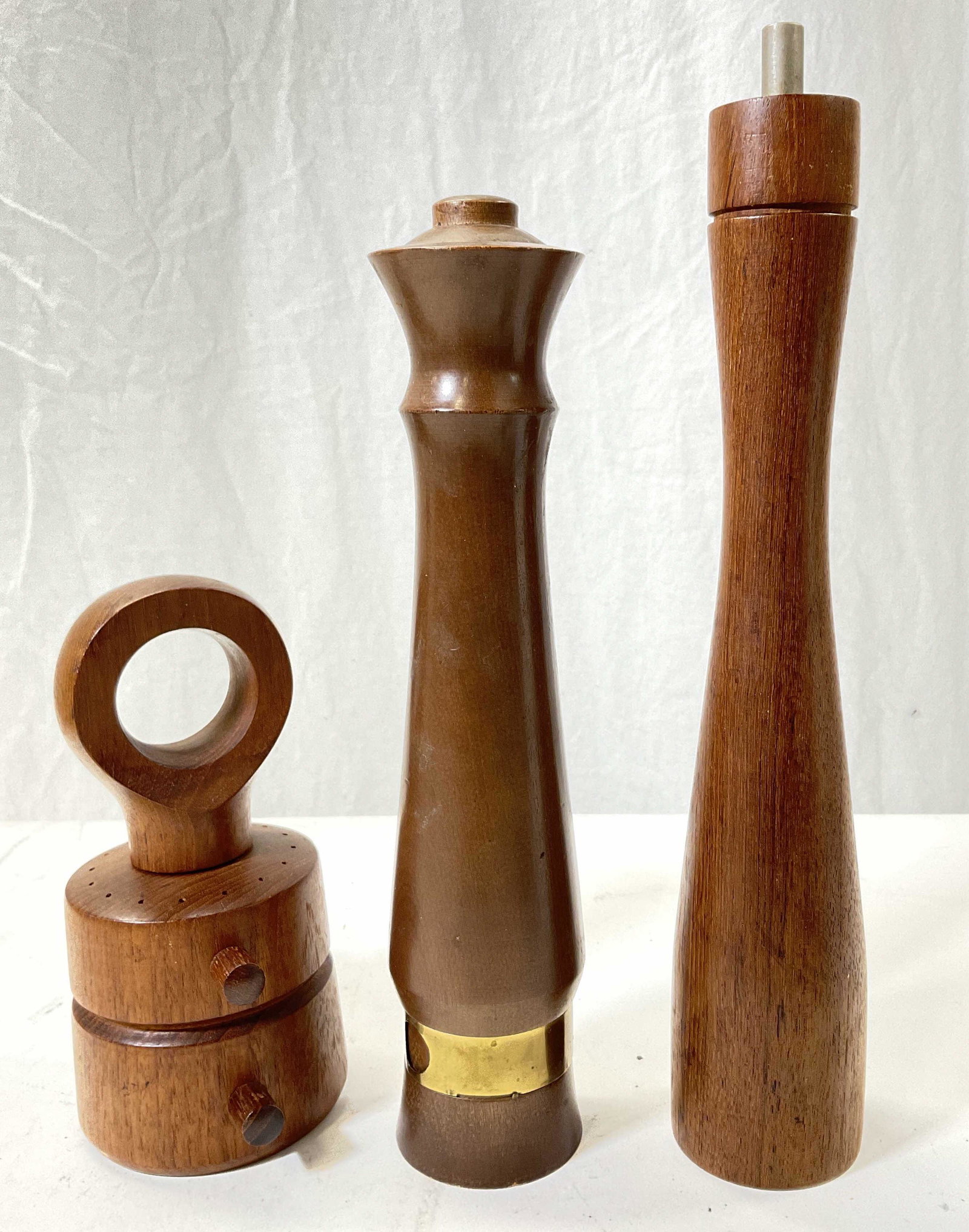 Lot 3 Wood Pepper Grinders, Denmark: 3 wood pepper grinders. Functional pieces, refillable. Some wear to pieces consistent with use. Tall pepper grinder has cork to refill. Two pieces read DENMARK at bottom. Tallest measures approx 12.5 