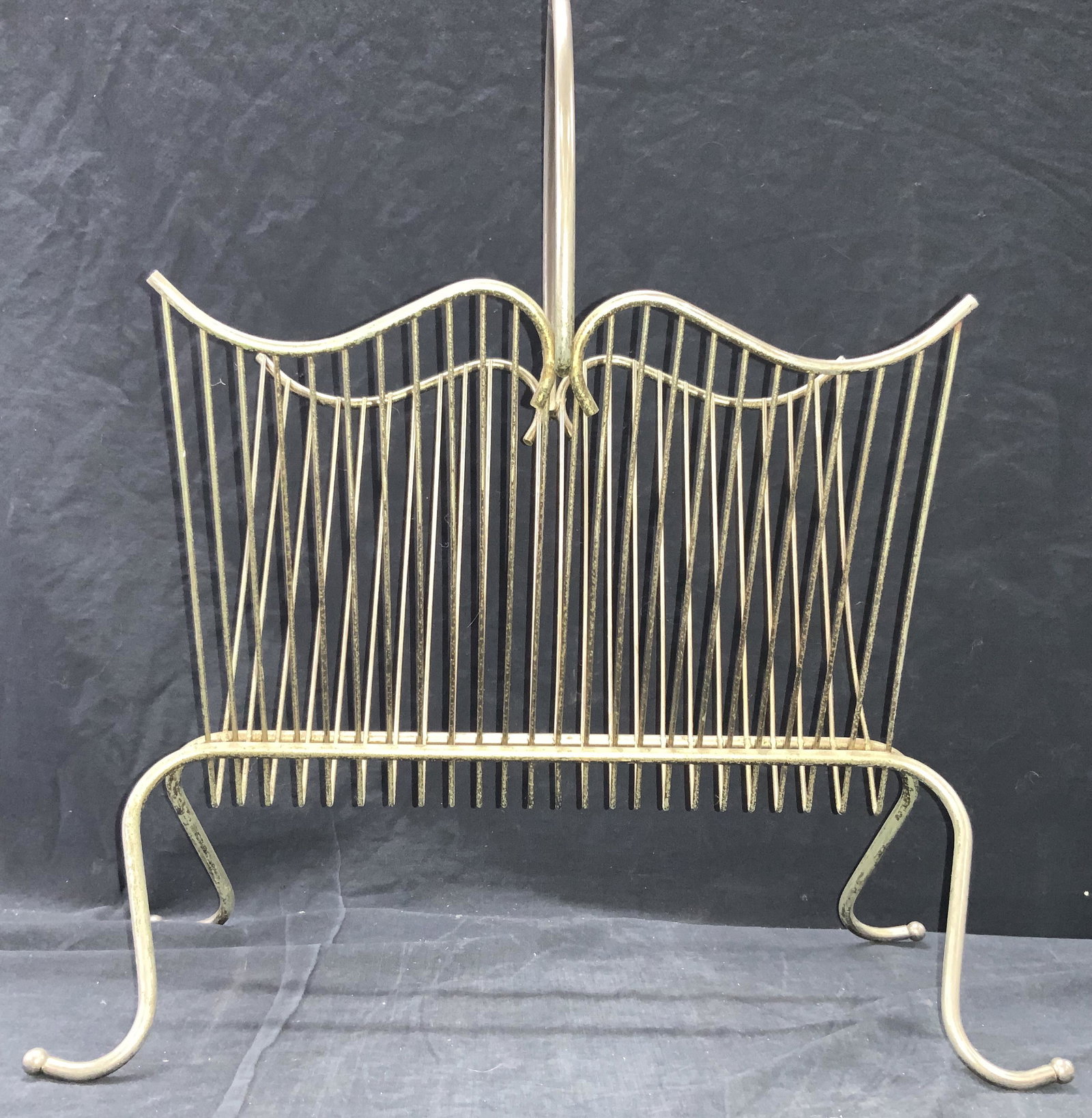 Vintage Metal Magazine Stand: Vintage white metal magazine stand with curved top frame and curved top handle. Approximately 20 inches tall from top handle and 13 inches long and 8.5 inches wide. Needs cleaning. Vintage magazine st