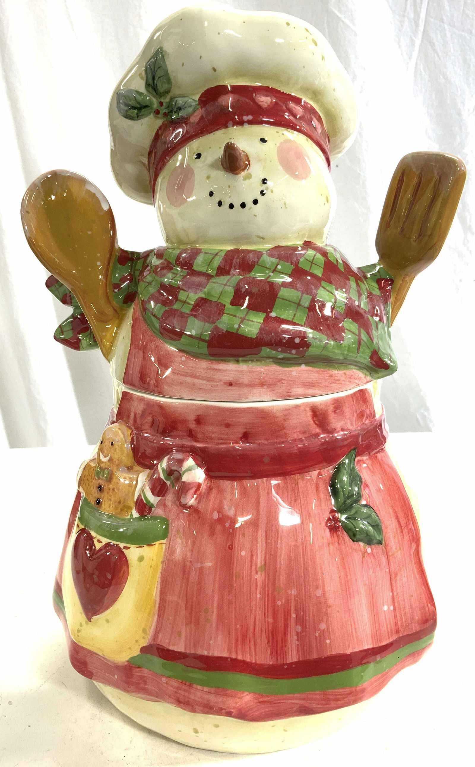 CERTIFIED INTERNATIONAL Porcelain Snowman Jar: Underside of piece is marked CERTIFIED INTERNATIONAL SWAN WINGETS. Jar is is porcelain. Piece depicts snowman chef with hat, holding spatula and spoon. Piece measures approx 14 inches tall 9 inches wi