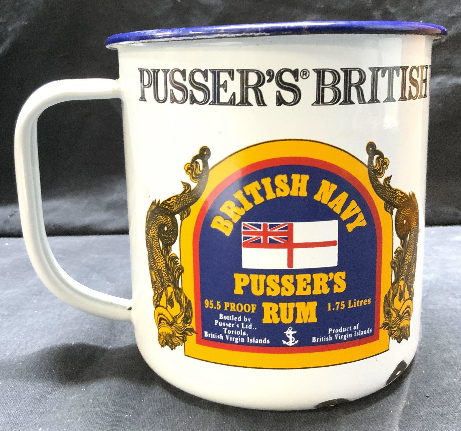 PUSSERS RUM BRITISH NAVY RUM Enameled Mug: Mug reads PUSSERS BRITISH VIIRGIN ISLANDS DRINKING MUG. Mug is vintage and enamel. Piece measures approx 5 inches tall & wide 6 inches deep with handle. Mug, vintage mag, PUSSERS rum mug, British navy