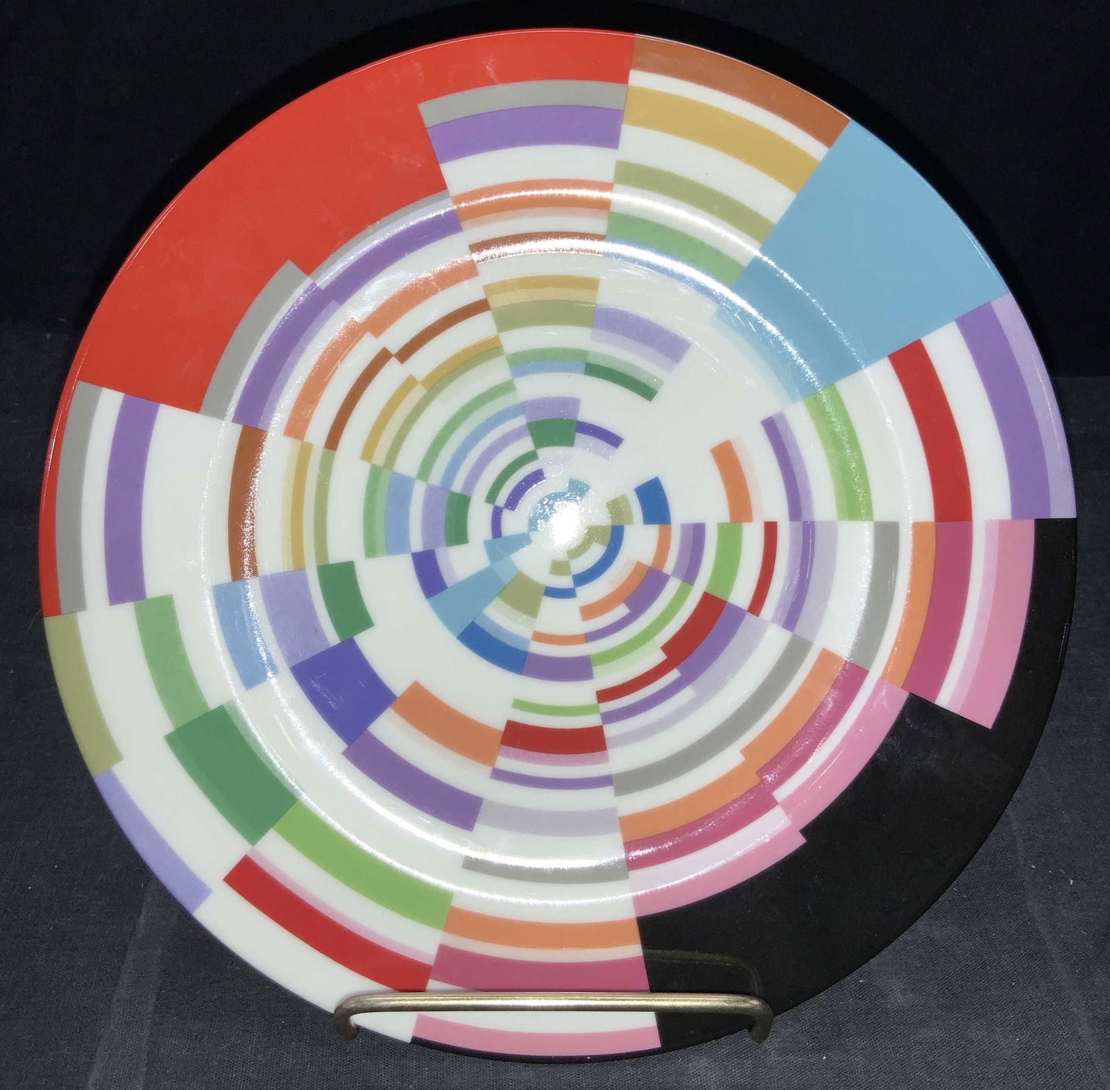 FELISSIMO Angela Missoni Designer Porcelain Plate: Porcelain plate with color blocking center of varying colors in a split geometric pattern. Backside is marked Angela Missoni, FELISSIMO, tribute 21. Approximately 8.25 inches wide. FELISSIMO porcelain