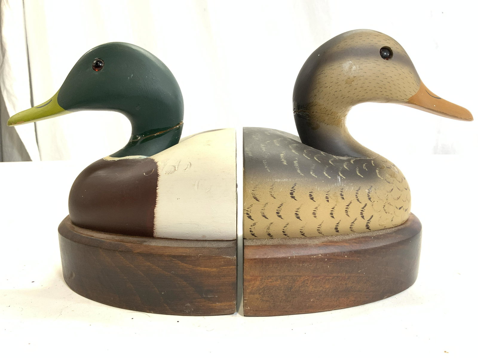 Wooden Painted Duck Bookends: Bookends appear to be wooden possibly veneer. Each Piece is carved and painted to resemble ducks. Bookends measure approx 6.5 inches tall 6 inches deep 5.5 inches wide. Bookends, Duck bookends, wooden