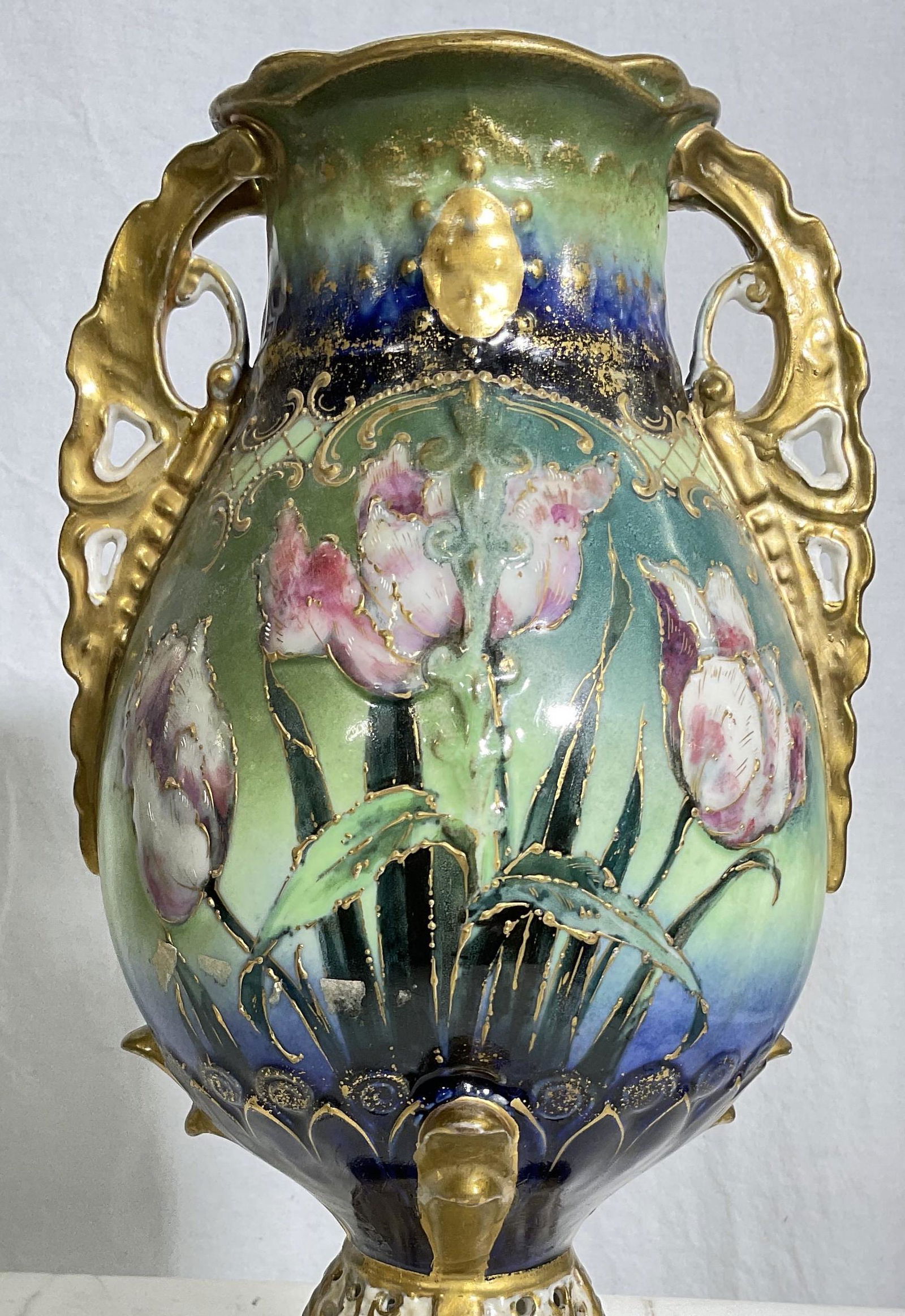 Amphora Vase W Floral Detail: Stamped vase at bottom reads Austria, Amphora. Piece has 2 handles with floral motif to sides and gold tones detailing. Measures approx 15 x 7 inches. Surface wear to piece consistent with age and use