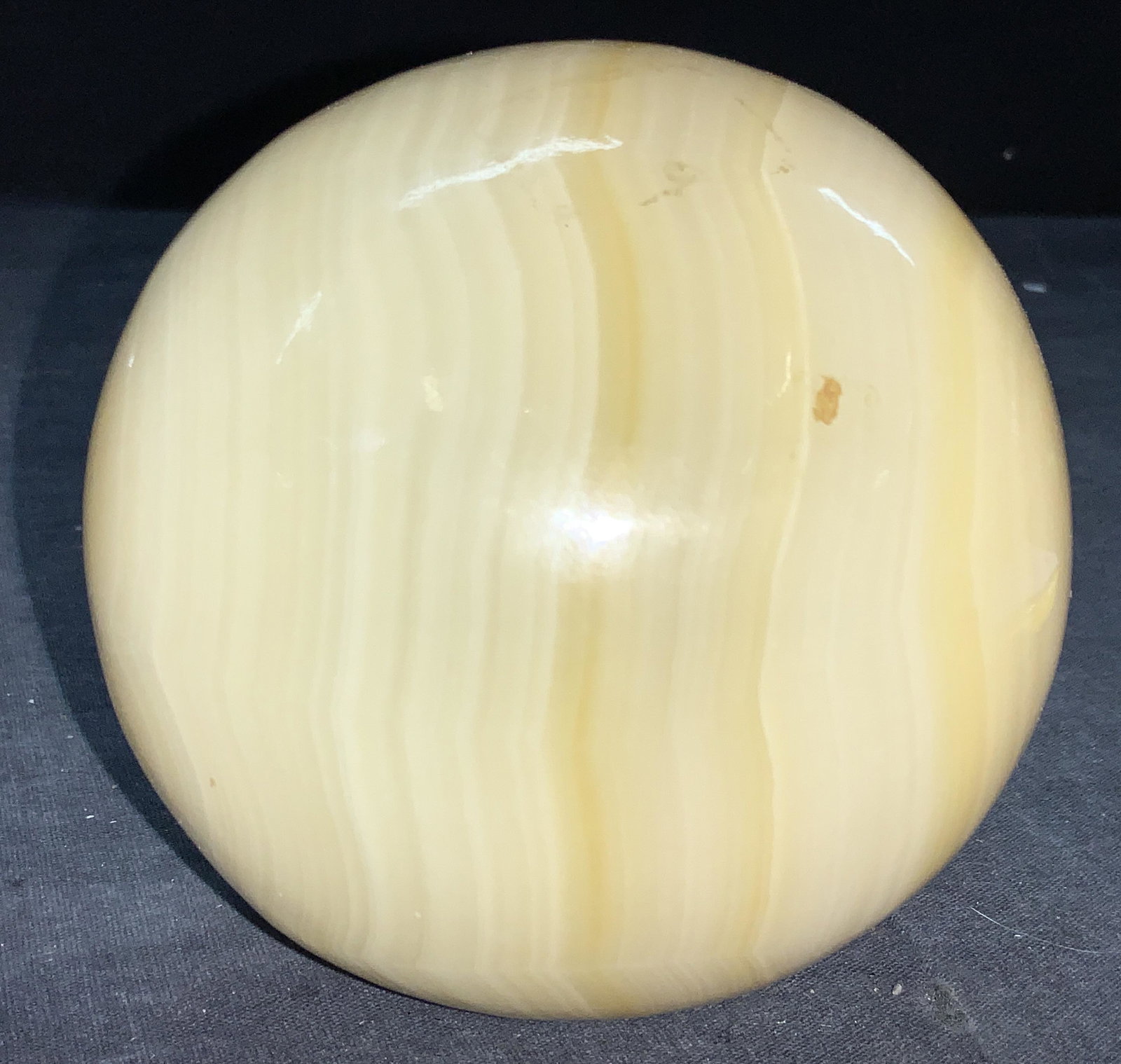 Natural Stone Alabaster Sphere: A natural stone sphere, possibly alabaster, moderate weight, yellow toned. Approximately 4.75 inches tall. Alabaster stone sphere, stone sphere, alabaster sphere, natural stone decor, stone decor, dec