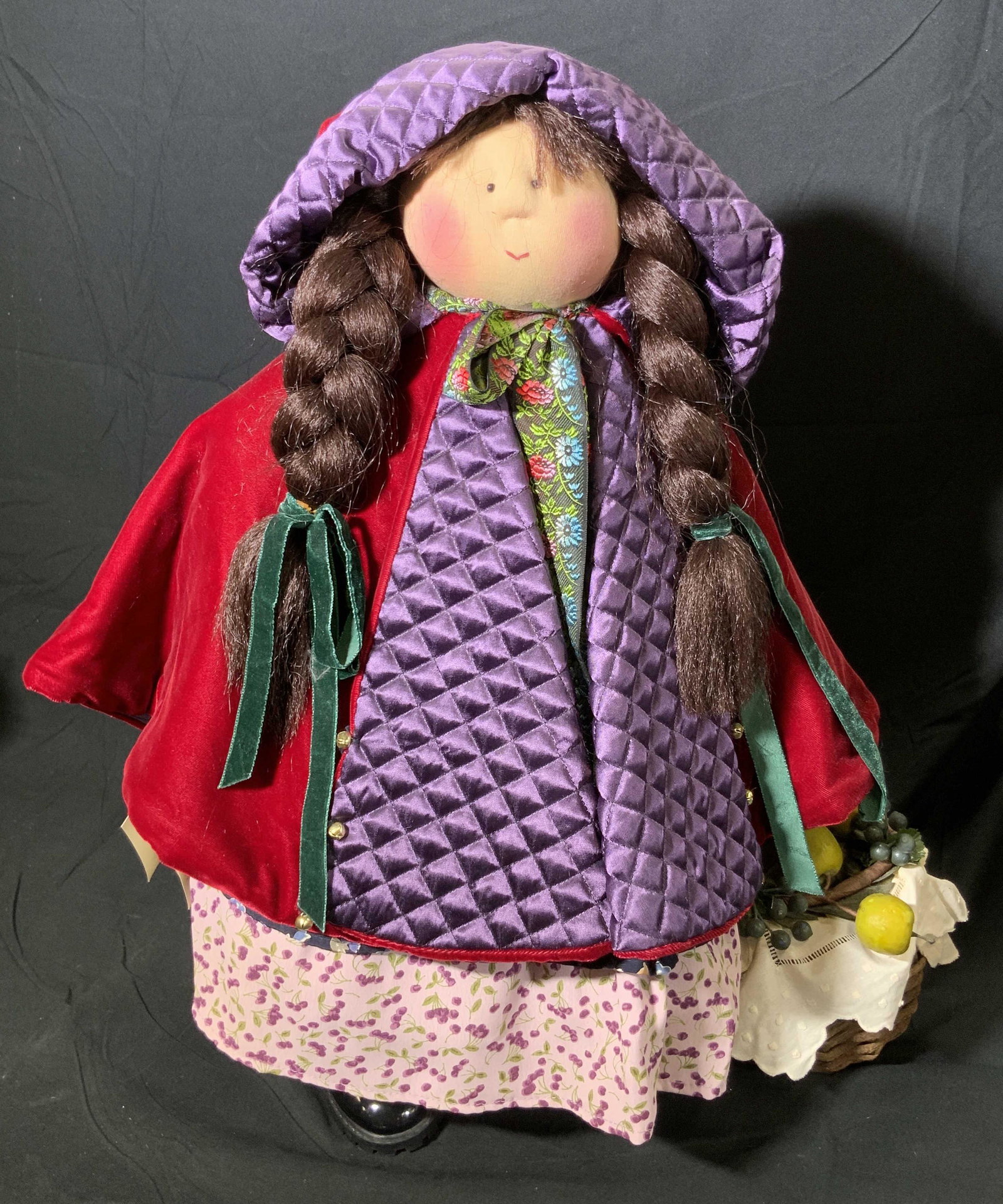 MS. R.R. HOOD by GRETCHEN WILSON 66/500 Doll: A 1996 LITTLE SOULS fabric doll MS. R.R. HOOD edition 66/500. Original tags attached. Doll wears a dress and cape. She holds a picnic basket in one hand. Affixed to stand. Measures approx 22H x 20W in