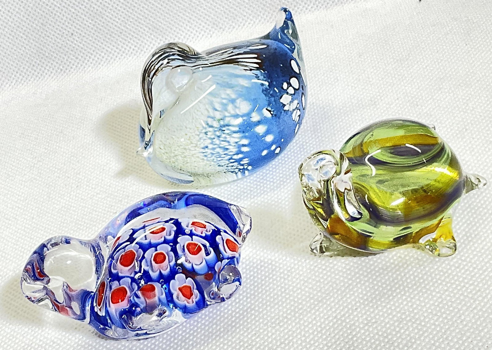 Lot 3 Glass Figurines: Lot 3 glass figurines, 2 are turtles. Duck is signed illegibly and states it’s made in Scotland. Largest one measures approx 2.5 x 1.5 inches. Each has an individual design within, attributed to Mil