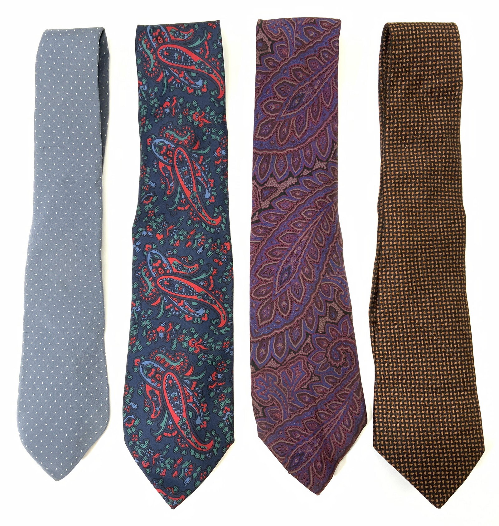 Group Luxury Designer Ties, BALENCIAGA, More: Group of 4 luxury designer ties. One purple paisley patterned BALENCIAGA tie, signed on interior fabric, possibly silk, measures approx. 59 inches. One black/brown patterned GIORGIO ARMANI tie, signed
