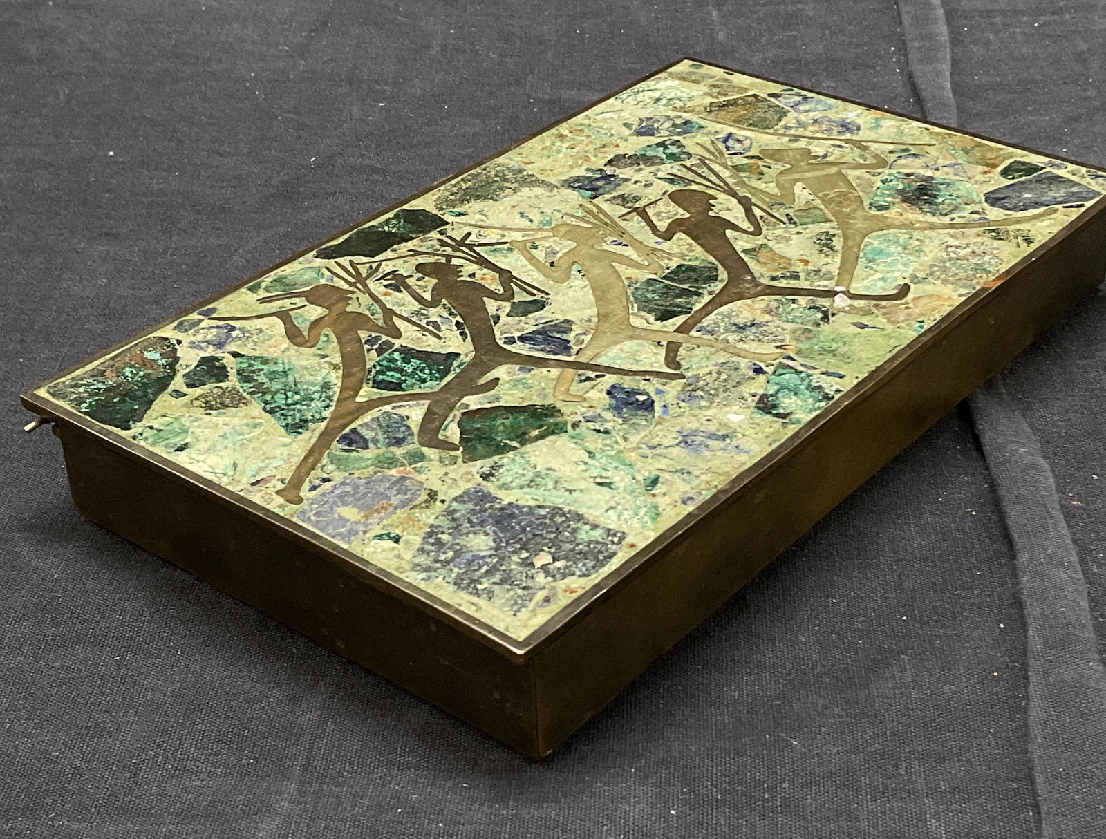 Mexican Styled Trinket Box W Inlaid Natural Stone: Box with figurines on top with inlaid natural stone. Stamped on bottom with Hecho En Mexico. Measures approx 7.5L x 4.5D x 1H inches. Some minor wear to box consistent with use and age. Box is of some