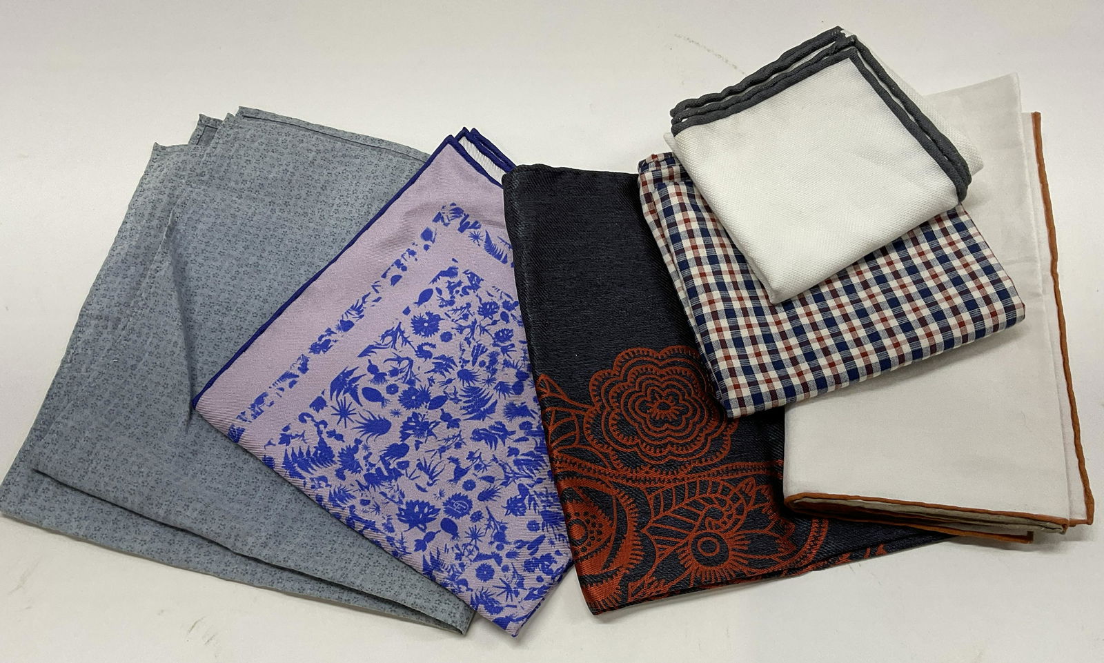 Lot 6 Handkerchiefs, Italy, UK: Largest measures 16 x 16 inches. 2 have not tags attached are white and have hand rolled Edges. 4 pieces have material tags and name tags to them which include, BRUNELLO CUCINELLI, GIEVES & HAWKS, BRE