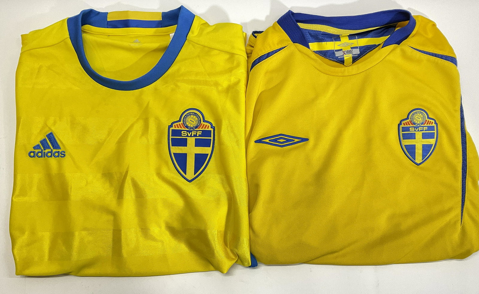 Lot 2 Swedish Football Sports Jerseys: One jersey is sized medium, the other is size Large. Wear to both jerseys consistent with use and age. Some stains. Yellow and blue colored. Swedish futbol emblem to front of jerseys. Jersey, futbol j