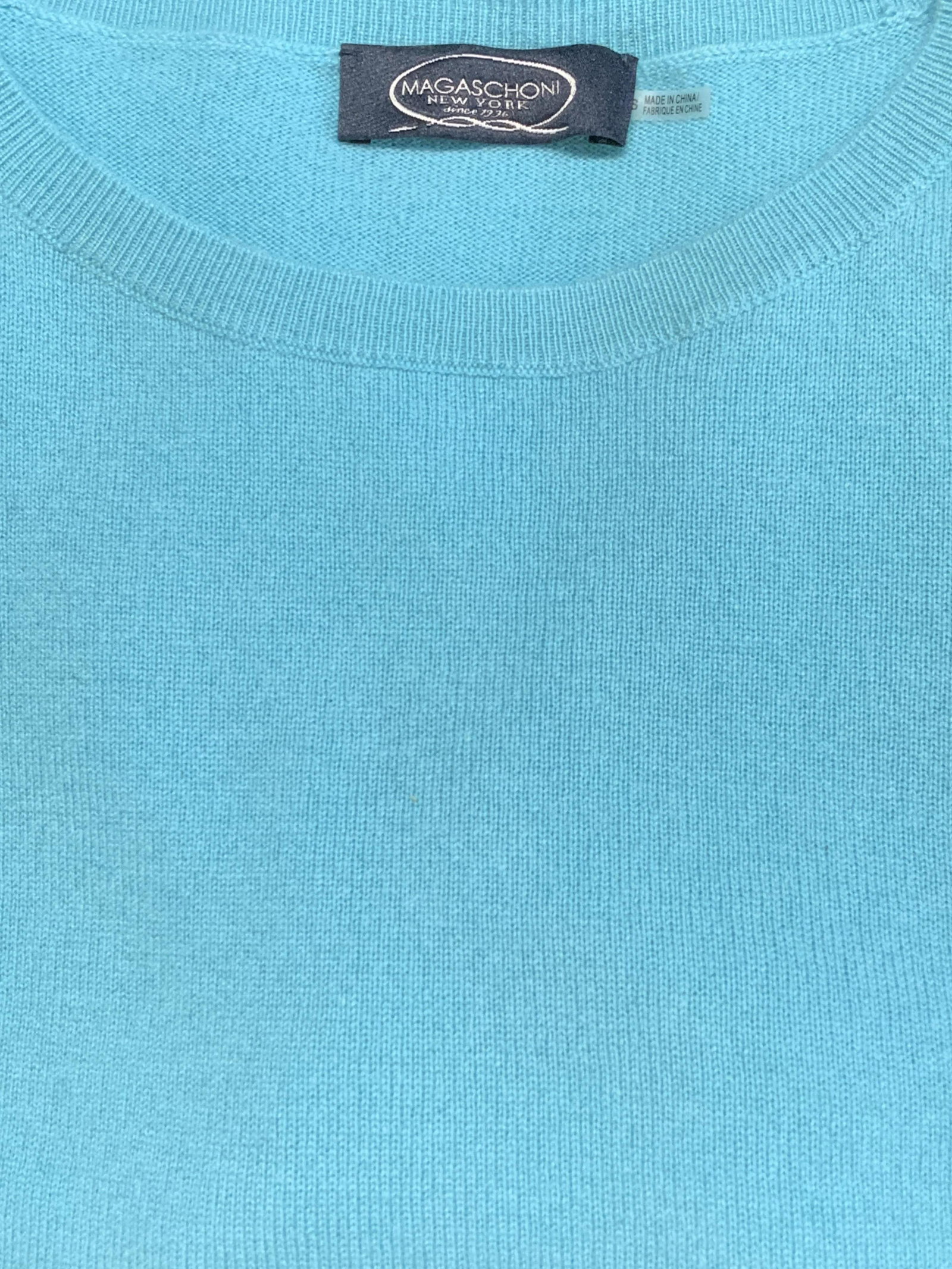 MAGASCHONI Asymmetric Zip Cashmere Sweater: MAGASCHONI light blue cashmere sweater with asymmetric hem and half zip detail. Marked size S on tag. 100% cashmere. In good condition, possibly never worn. Magaschoni is a leading American cashmere a