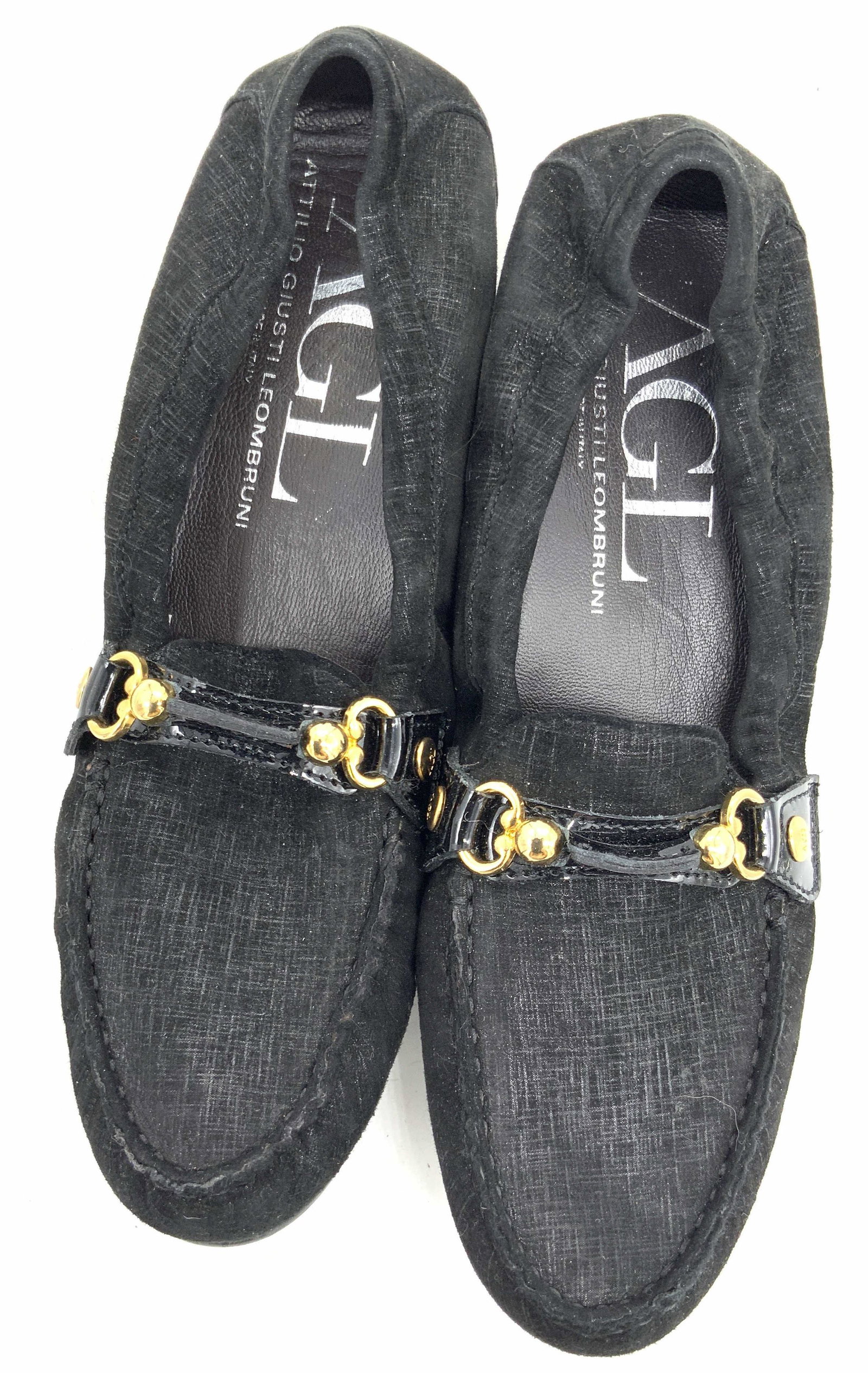 AGL Attilio Giusti Leombruni Italian Loafers Shoes: Black loafer style shoes with gold tone metal hardware. Interior reads AGL Attilio Giusti Leombruni, Made in Italy. Appears to be crafted from suede and rubber materials. AGL has been handcrafting bea