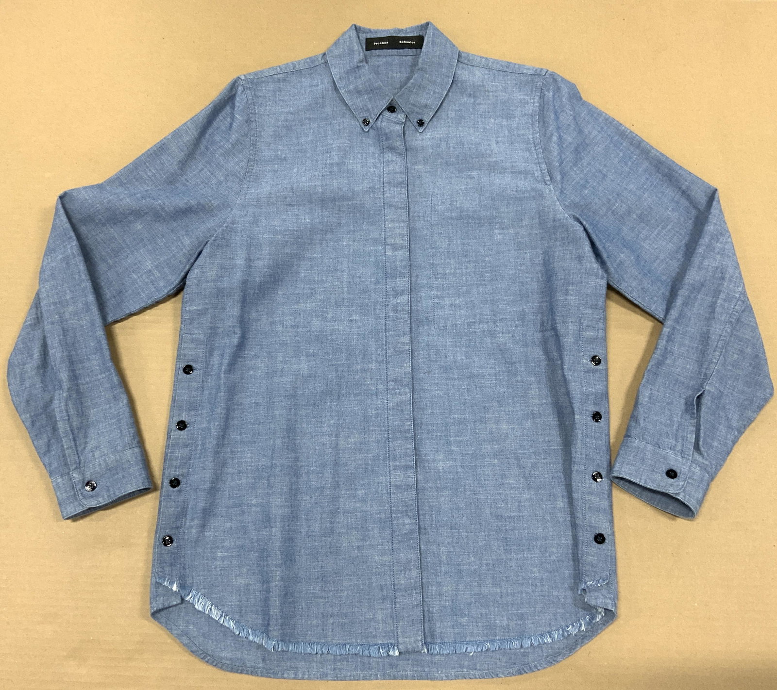 PROENZA SCHOULER Blue Denim Button Up Shirt: PROENZA SCHOULER Blue Denim Button Up Shirt, ladies size 4, fringed hem, interior breast pocket, possibly never worn. PROENZA SCHOULER is a line created in 2002, dedicated for womenswear and accessori
