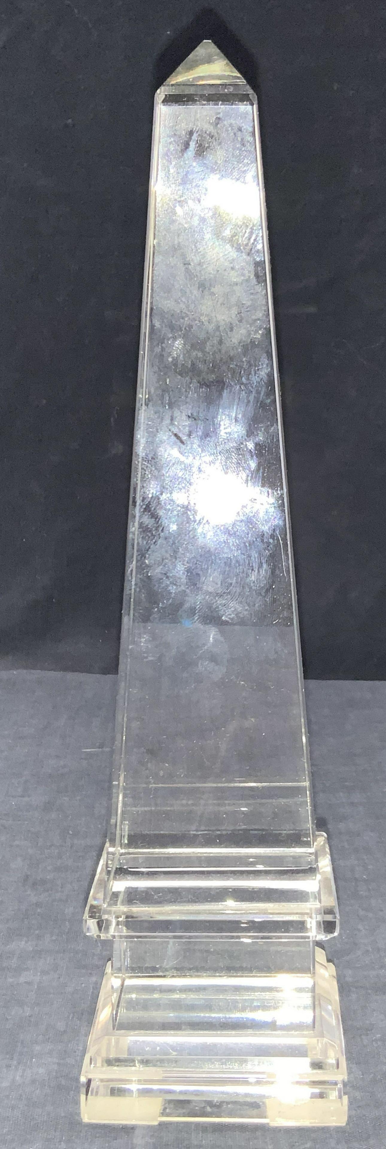 Clear Cut Glass Obelisk: A clear cut obelisk with protective pads on underside. Approximately 10 inches tall. Clear Glass obelisk, glass obelisk, obelisk, decorative glass obelisk, tabletop accessories and decor, tabletop orn