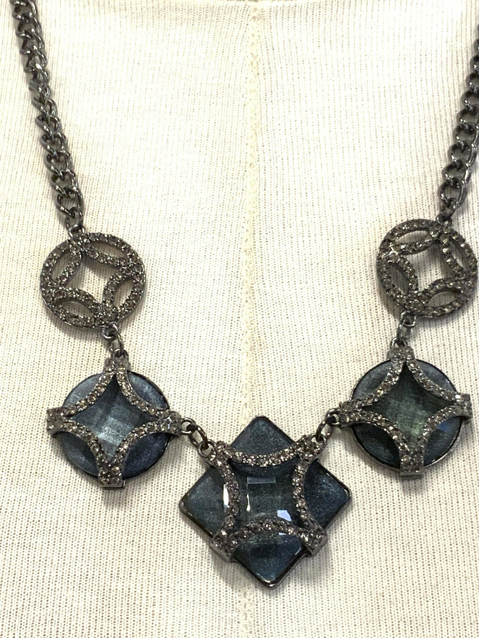 Faceted Crystalline Statement Necklace: Faceted Crystalline Statement Necklace, grey toned metal strand, lobster claw clasp, rhinestone detail, adjustable length measures approx 21 1/4 in. long. Property of Trump Tower Manhattan and Bedford