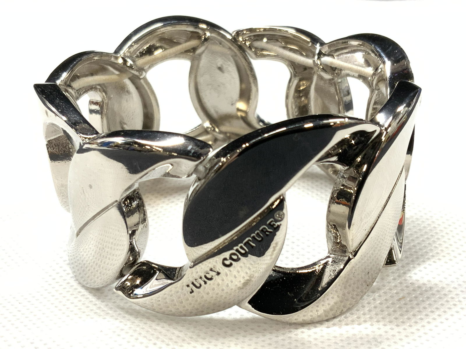 JUICY COUTURE Signed Stretch Bracelet: A stretch bracelet with knotted design. Marked Juicy Couture on side. Approximately 2.75 inch diameter. Juicy couture bracelet juicy couture jewelry, Signed designer jewelry,Estate Jewelry, Costume Je