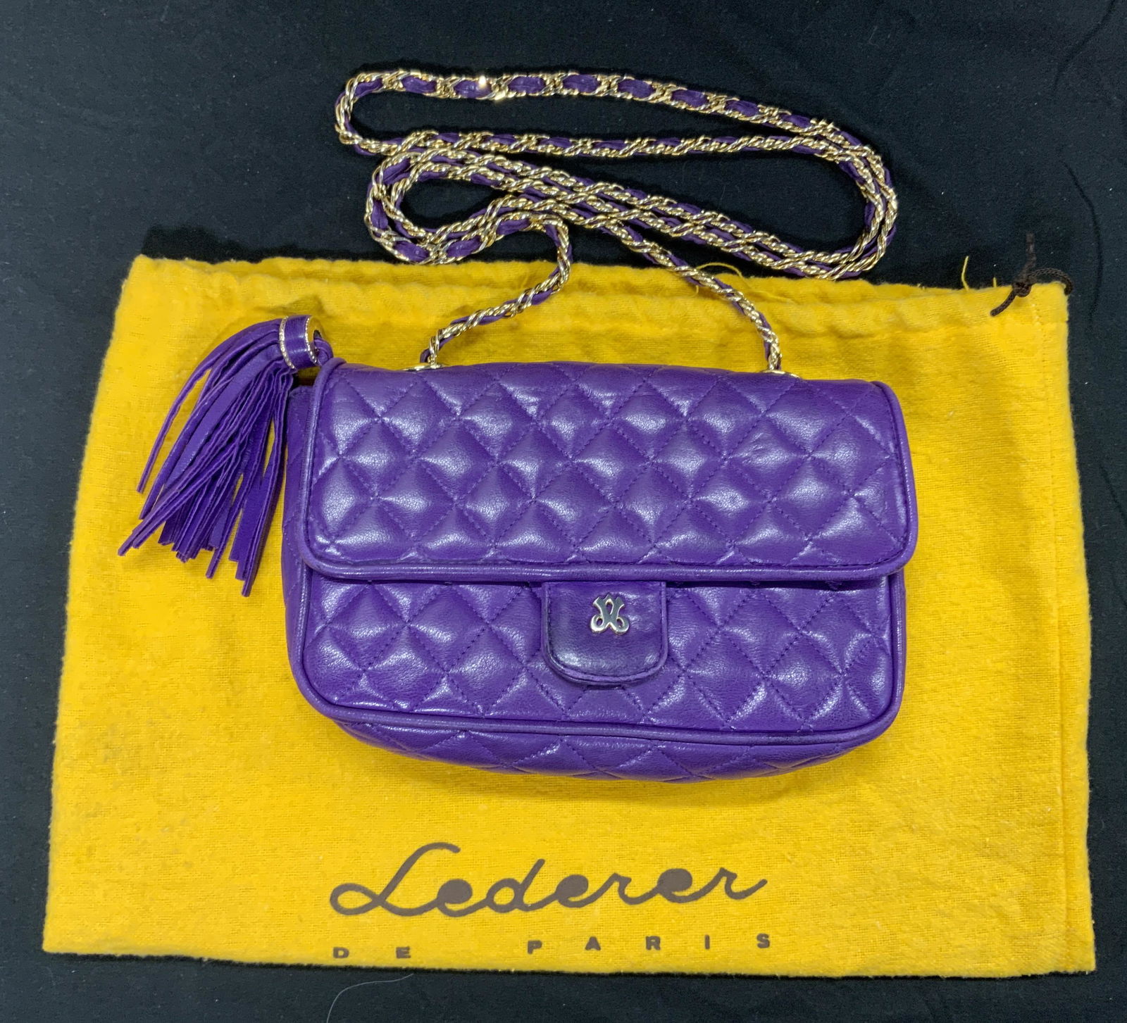JAY HERBERT Vintage Quilted Purple Shoulder Bag: Signed JAY HERBERT vintage quilted shoulder bag in purple. Gold tone hardware, woven chain and leather strap. Snap button closure. Tassel detail. Interior black leather lined with on zip pocket. Signe