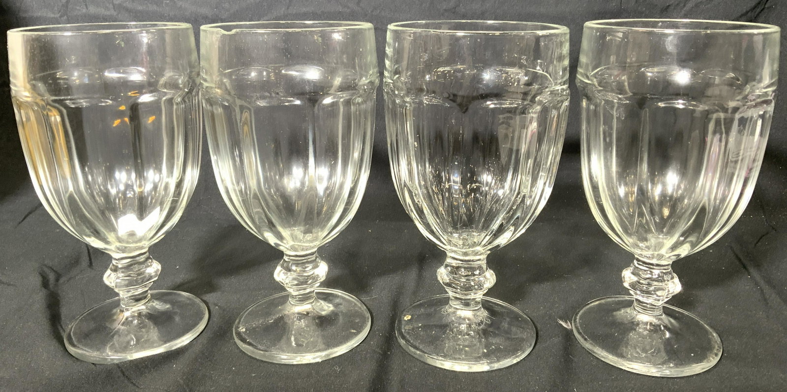 Set 4 Dessert Glasses Stemware: Lot includes 4 glasses. Each have stems with circular shaped bases. Each measures approx 7 inches tall 3.5 inches wide. Glasses, glassware, stemware, dessert glasses, Barware. Chips present. 6