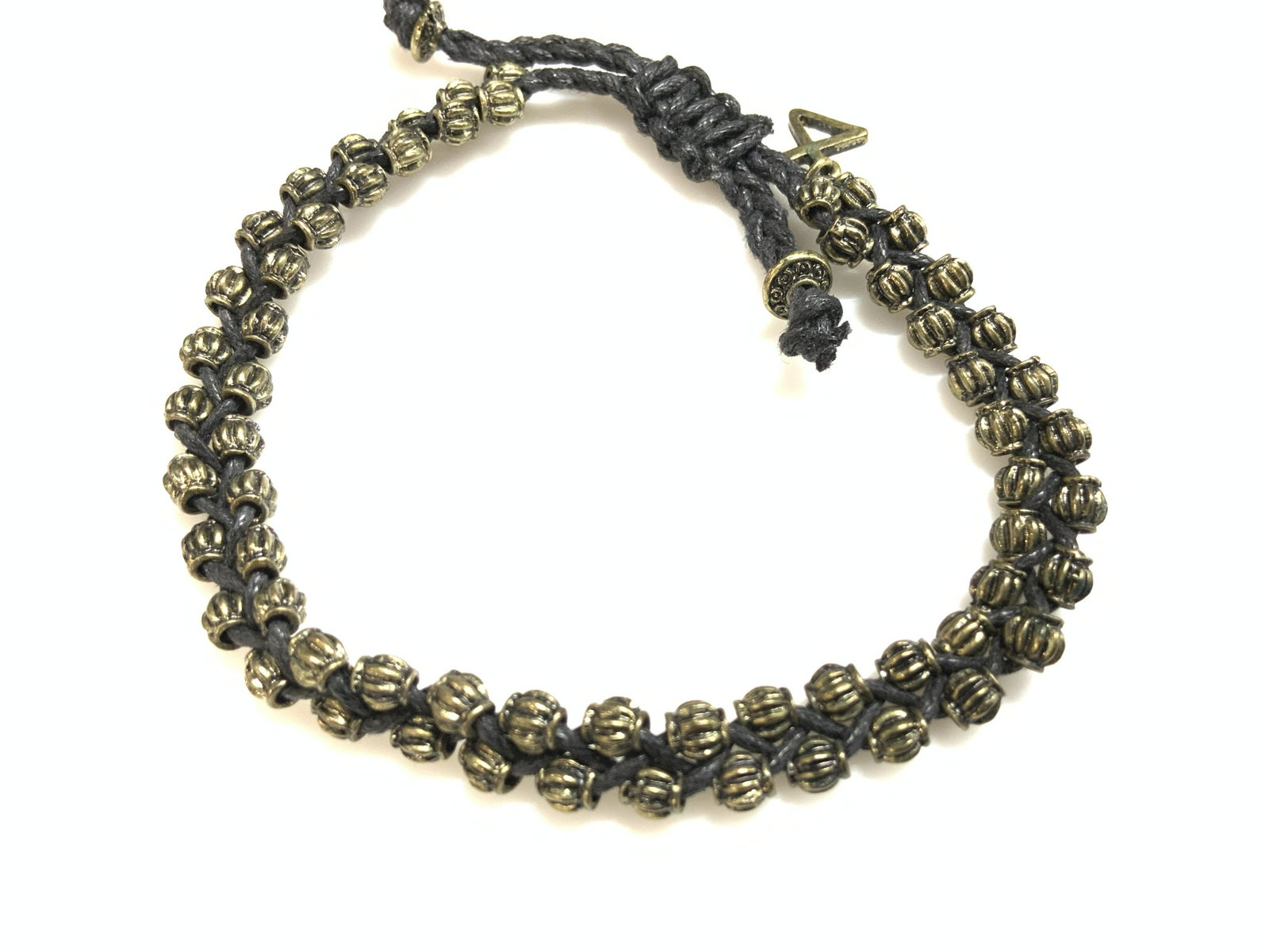 Handmade Crochet Bracelet w Brass Tn Beads: Crocket black rope bracelet with interwoven Reticulated metal beads, embossed and brass/ bronze toned. Fits over hand, signed on charm. 3.5 in. diameter. Artisanal jewelry, Arts and crafts jewelry, Br