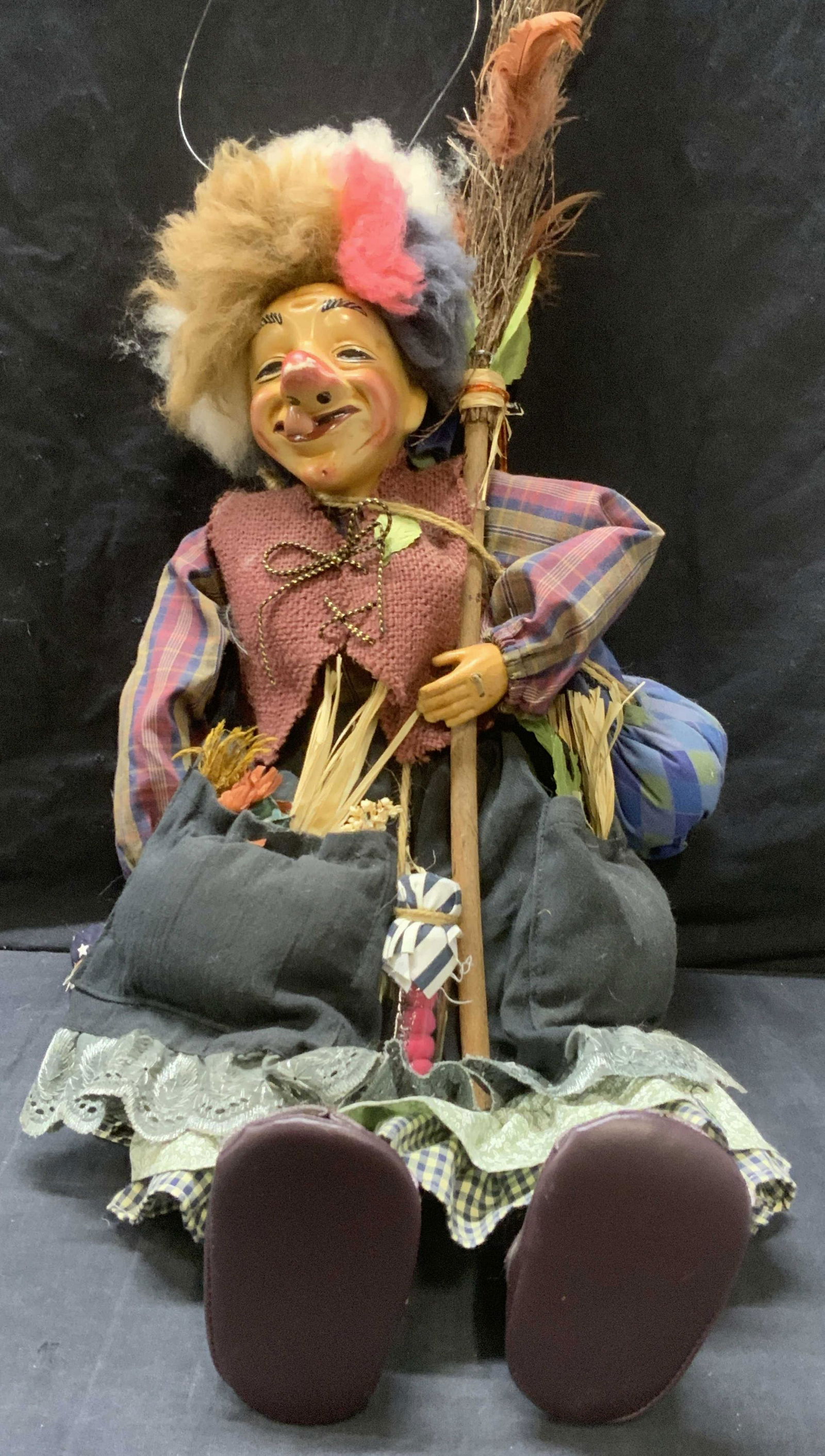Clown Witch Doll Decoration: Clown Witch Doll Decoration, with plastic loop for hanging convenience, resin head and textile body, holding a jar and a broom, measures approx 22 in. long. Clown witch doll decoration, decorative dol