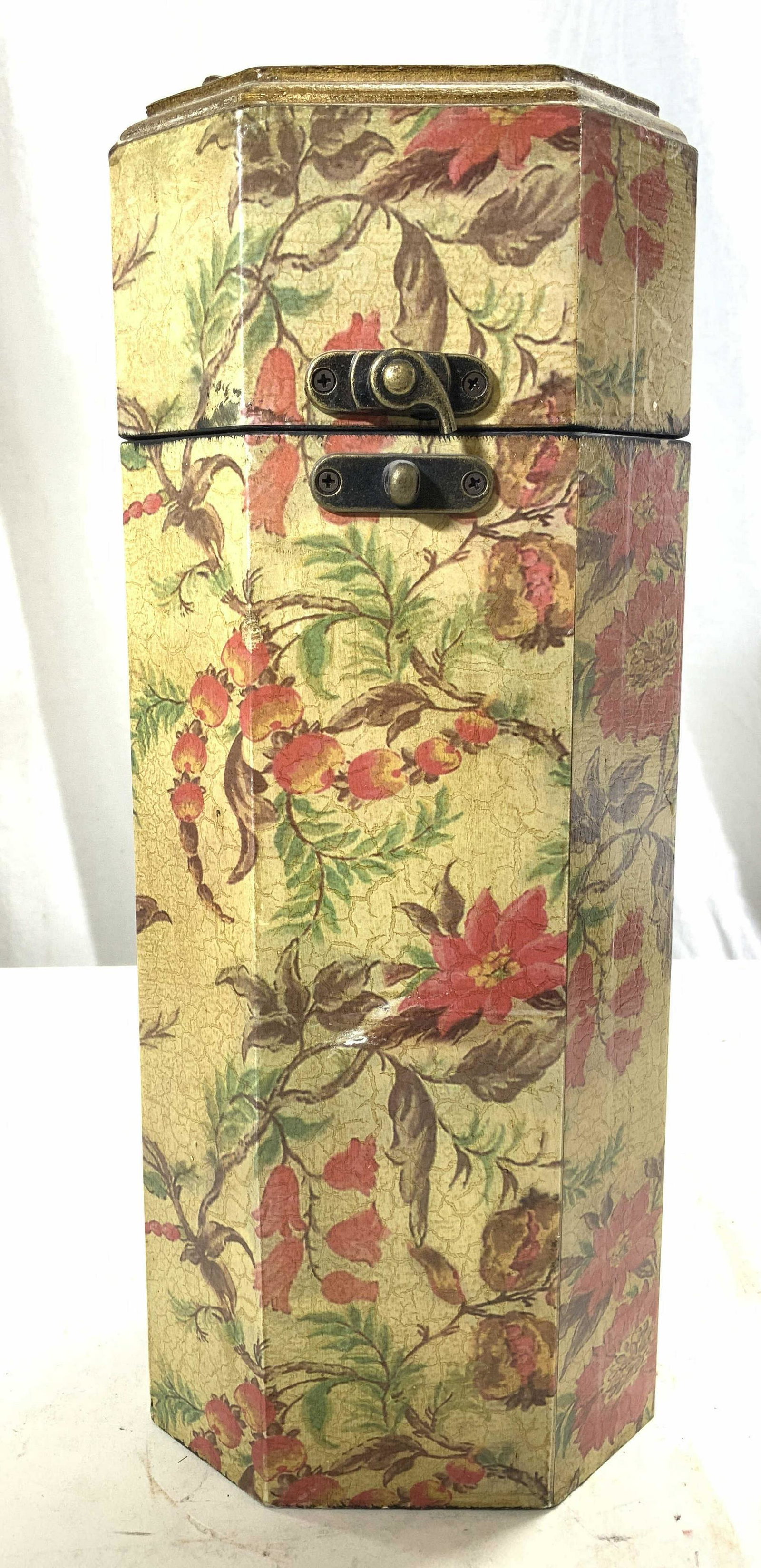 Wine Bottle Holder Box W Lid & Handle: Box has multi toned floral, vine, leaf & fruit detail. Piece has lid with gold toned metal handles at top. Piece has octagonal shape. Box measures approx 14 inches tall 5 inches wide & deep. Wine box,