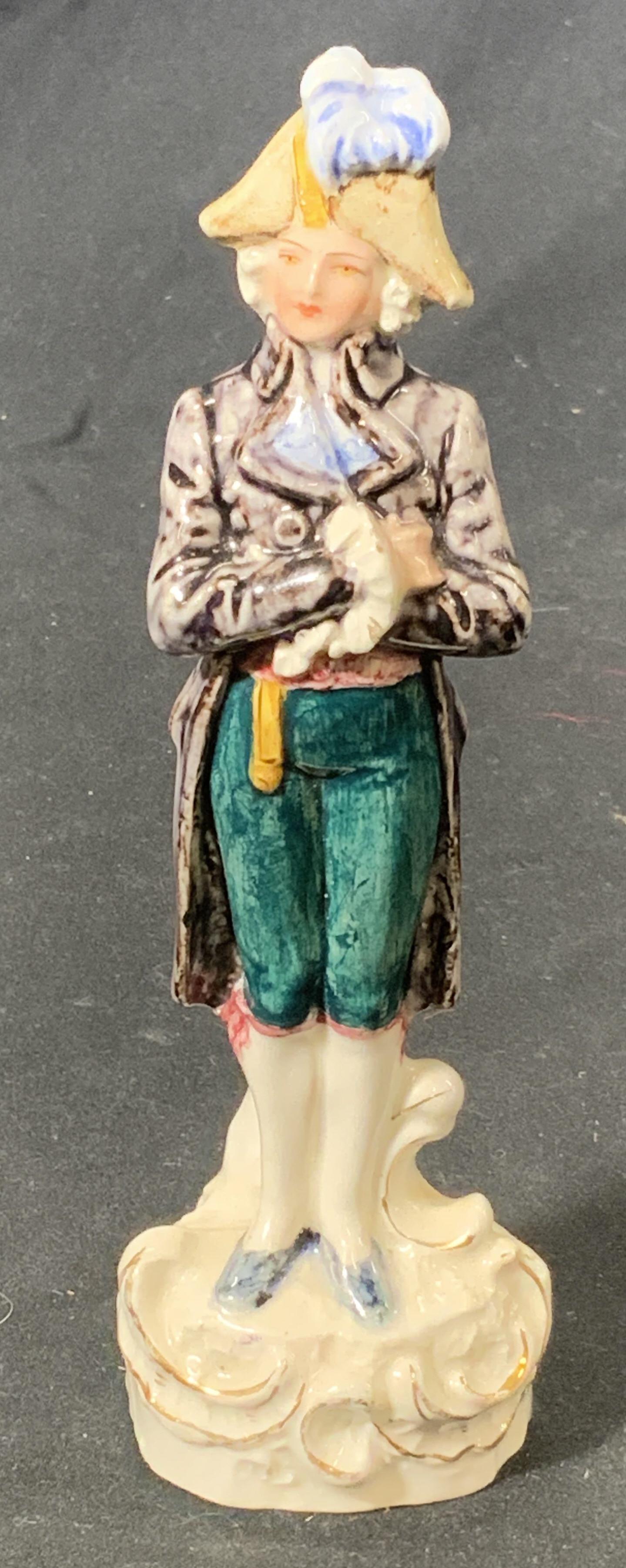 ROYAL DUX Vintage Porcelain Figurine, Germany: A vintage ROYAL DUX porcelain figurine of a man with gilded hand painting to base. Made in Germany. Measures approx. 6 x 1.75 inches. Vintage condition, some loss to paint. Signed to underside. Proper