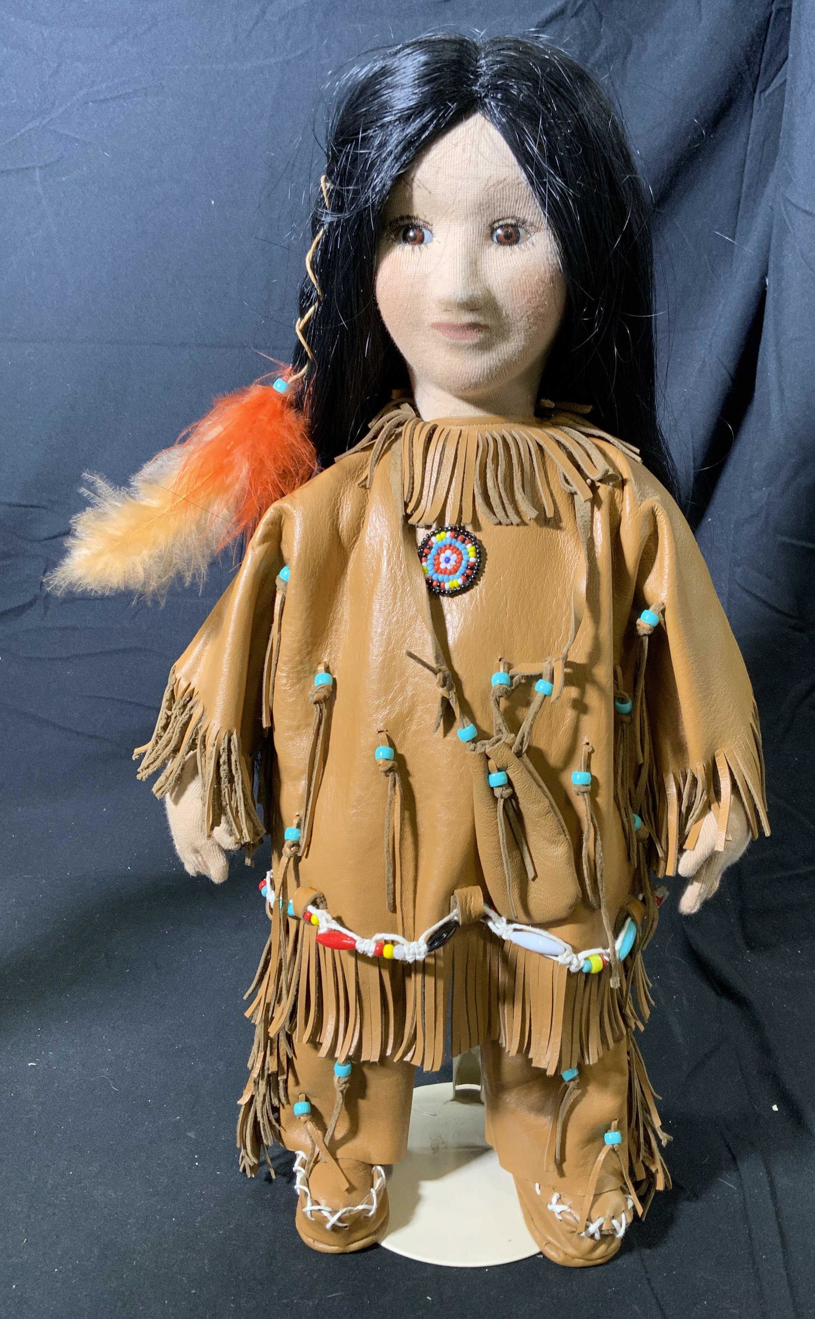 BARBARA OGDEN Handcrafted Native American Doll: A handcrafted Barbara Ogden fabric Artist doll. Native American girl in tan leatherette shirt and pants with beaded details. Hand painted face. Doll measures approx. 17.5 inches. Signed BARBARA OGDEN 