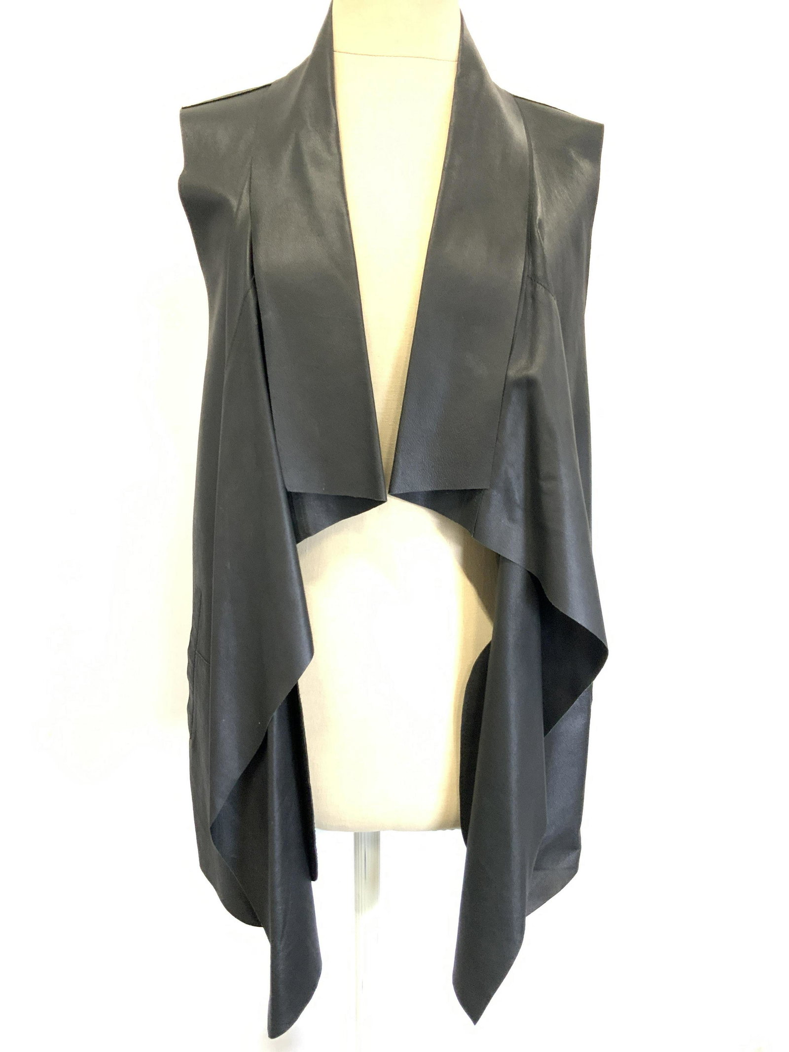 SAKS FIFTH AVENUE Leather Eveningwear Vest: A black leather vest with front pockets. Designer tag reads Saks Fifth Avenue, size Medium. Material tag reads 100% Leather. Minor blemishes to exterior. Saks fifth Avenue clothing, leather vest, Saks
