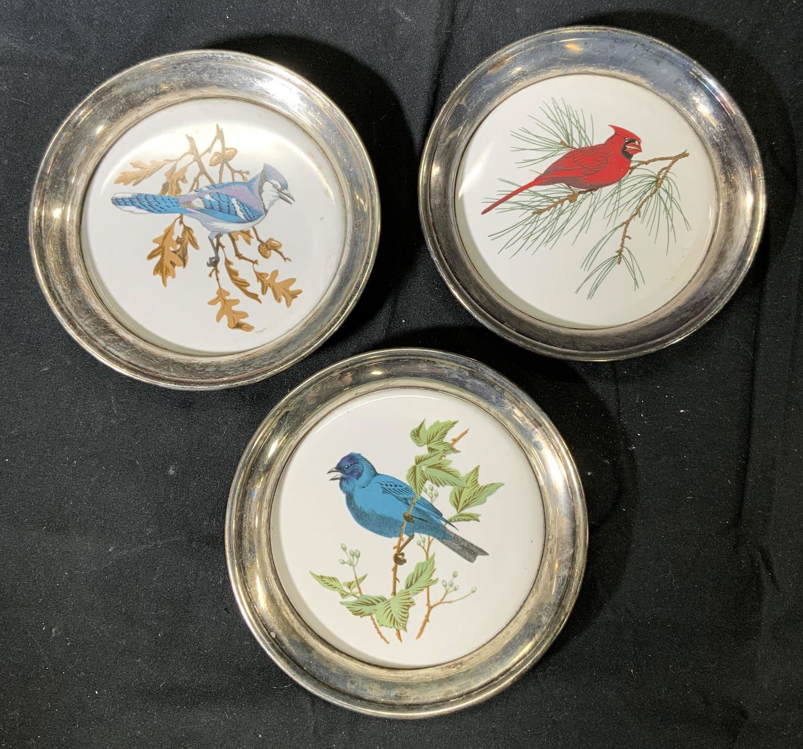 SHERIDAN SILVER Vintage Bird Coasters: Set of 3 vintage Sheridan Silver Company coasters with images of birds. Vintage condition with wear consistent with age, use, and exposure. Measure approx. 4.5 inches each. May be used as trinket dish