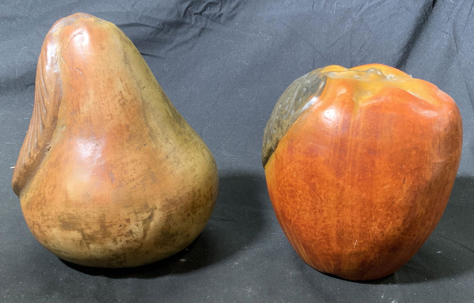 Vintage Apple & Pear Sculptures: Vintage hand painted composite sculptures of an apple and a pear. Some loss of paint. Pear measures 6.5 inches diameter and 8 inches tall. Apple measures approx. 6 inches diameter and 6.25 inches tall