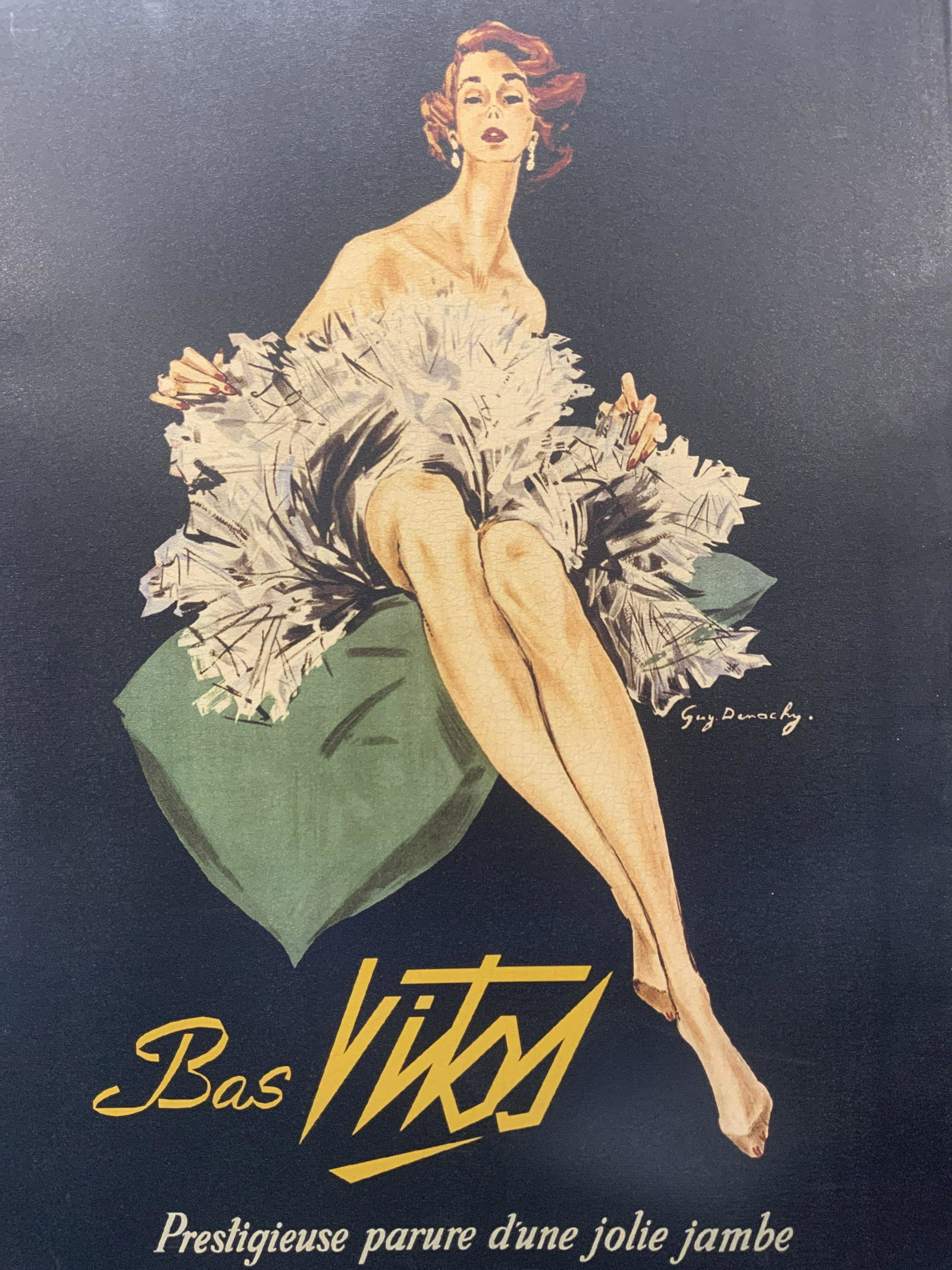 GUY DEMACHY Bas Vitos Stockings Ad. LithographXL: GUY DEMACHY Bas Vitos Stockings Advertisement Lithograph on canvas, signed Guy Demachy, inscriptions read Bas Vitos Prestigieuse parure d une Jolie jambe, subject shows a woman in a dress sitting on a