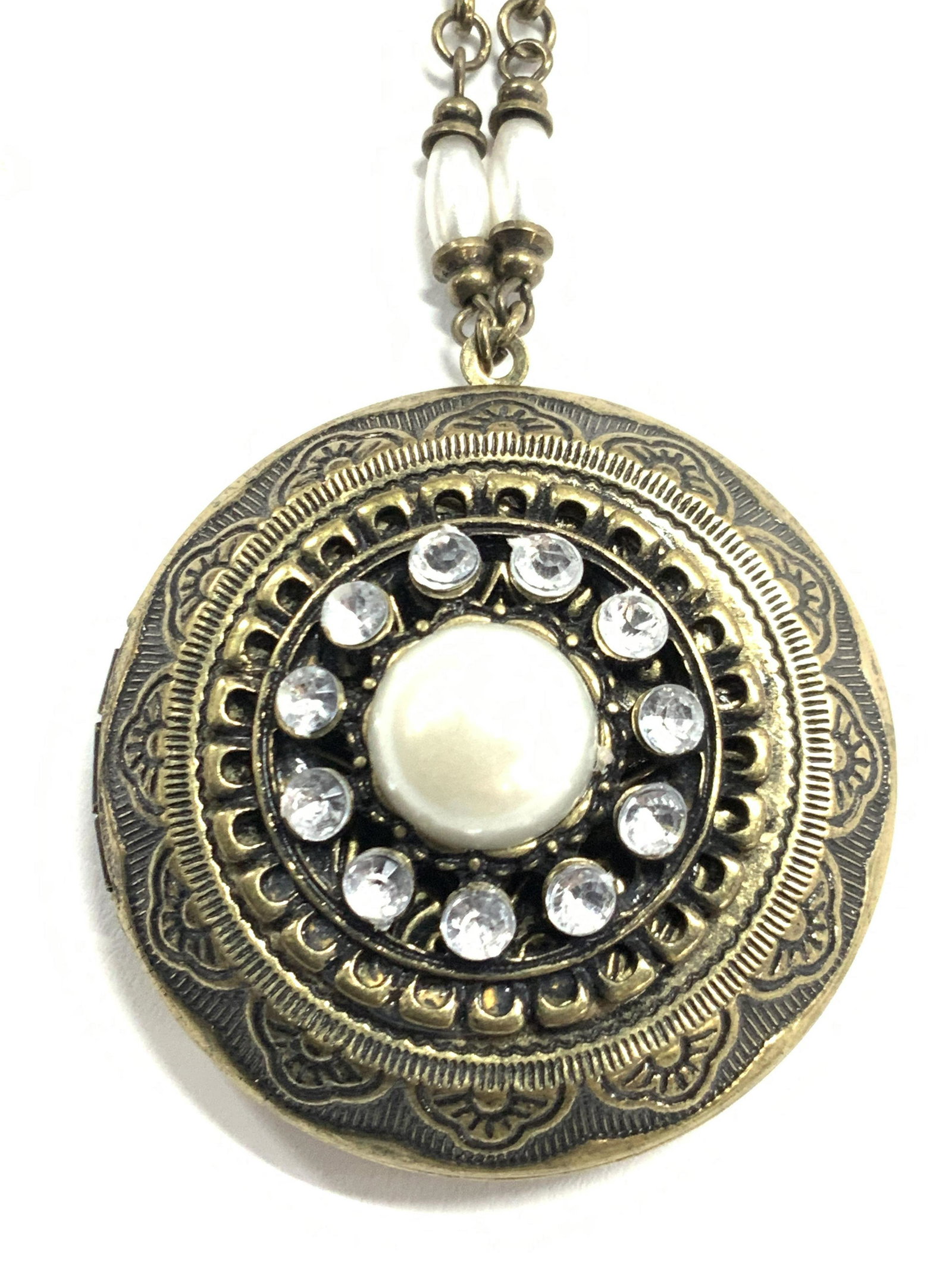 ROBERT ROSE Rope Statement Locket Necklace: A rope length locket necklace with pearlescent spacer beads. Locket is brass toned and etched. Center of locker has a pearlescent Cabochon with a Halle of faceted rhinestones. Approximately 19 inches 