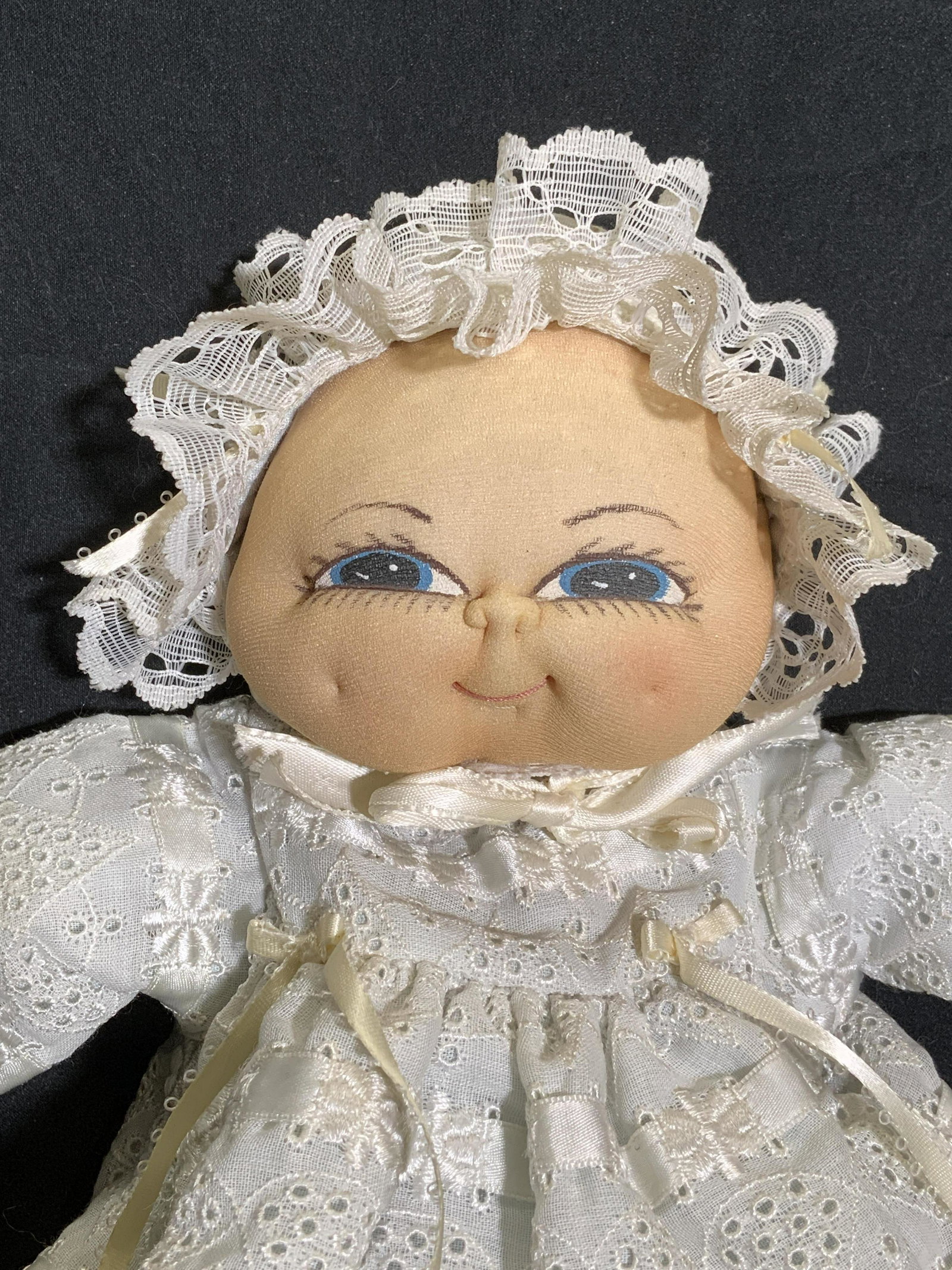 Vintage Baby Doll, Floral Embroidered Dress: Vintage textile baby doll with painted face and blue and white floral embroidered dress and matching bonnet. Some minor flaws, fraying to fabric. Doll measures approx. 13 inches long. Vintage doll, ba