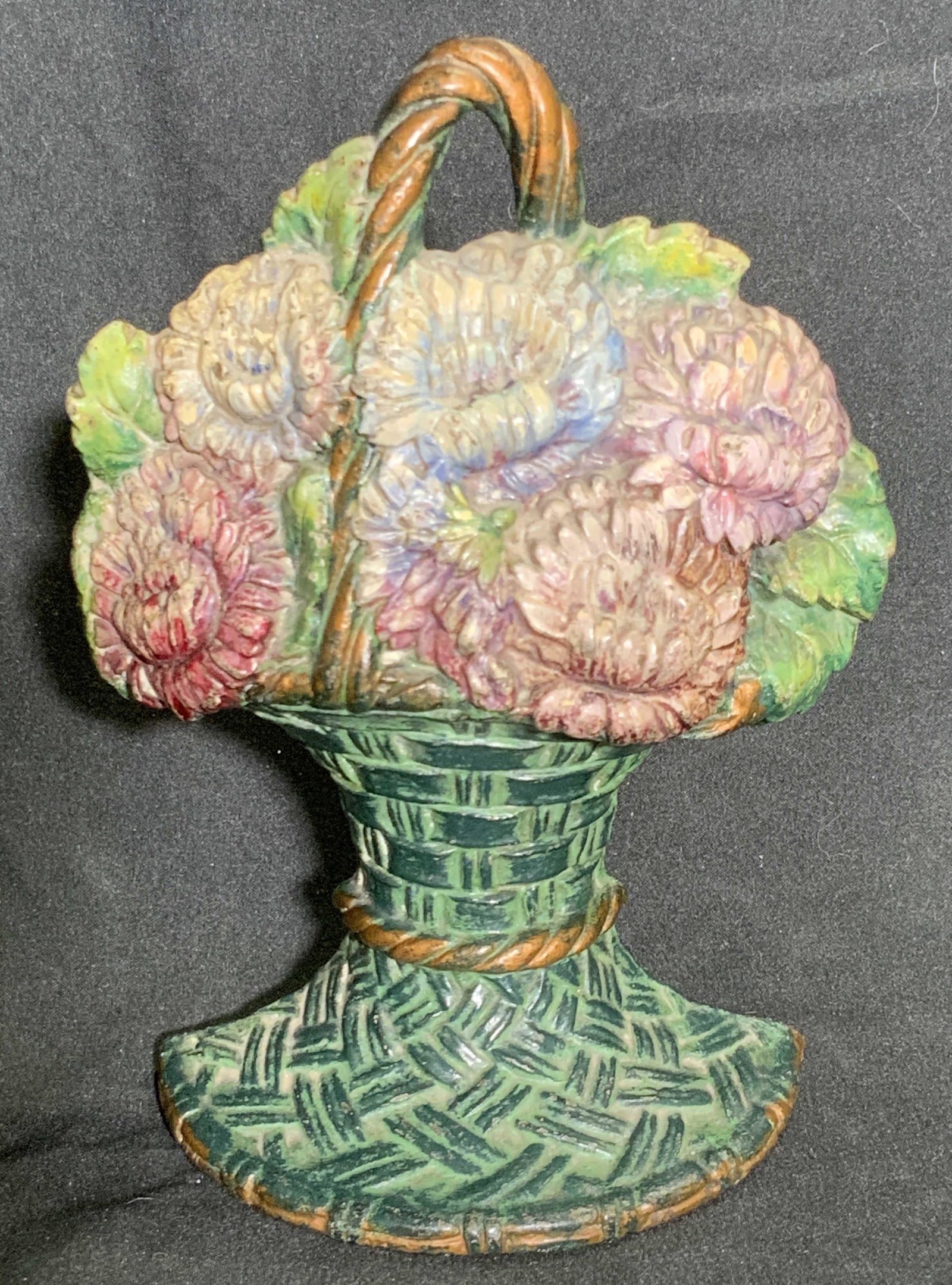 WAVERLY STUDIO Wilmette ILL C. 1925 Doorstop: A hand painted iron floral form doorstop. Primarily green, pink, and blue hues. Reverse reads WAVERLY STUDIO Wilmette ILL Copyright 1925. Measures approx 7H x 5W in. Surface wear consistent with age a