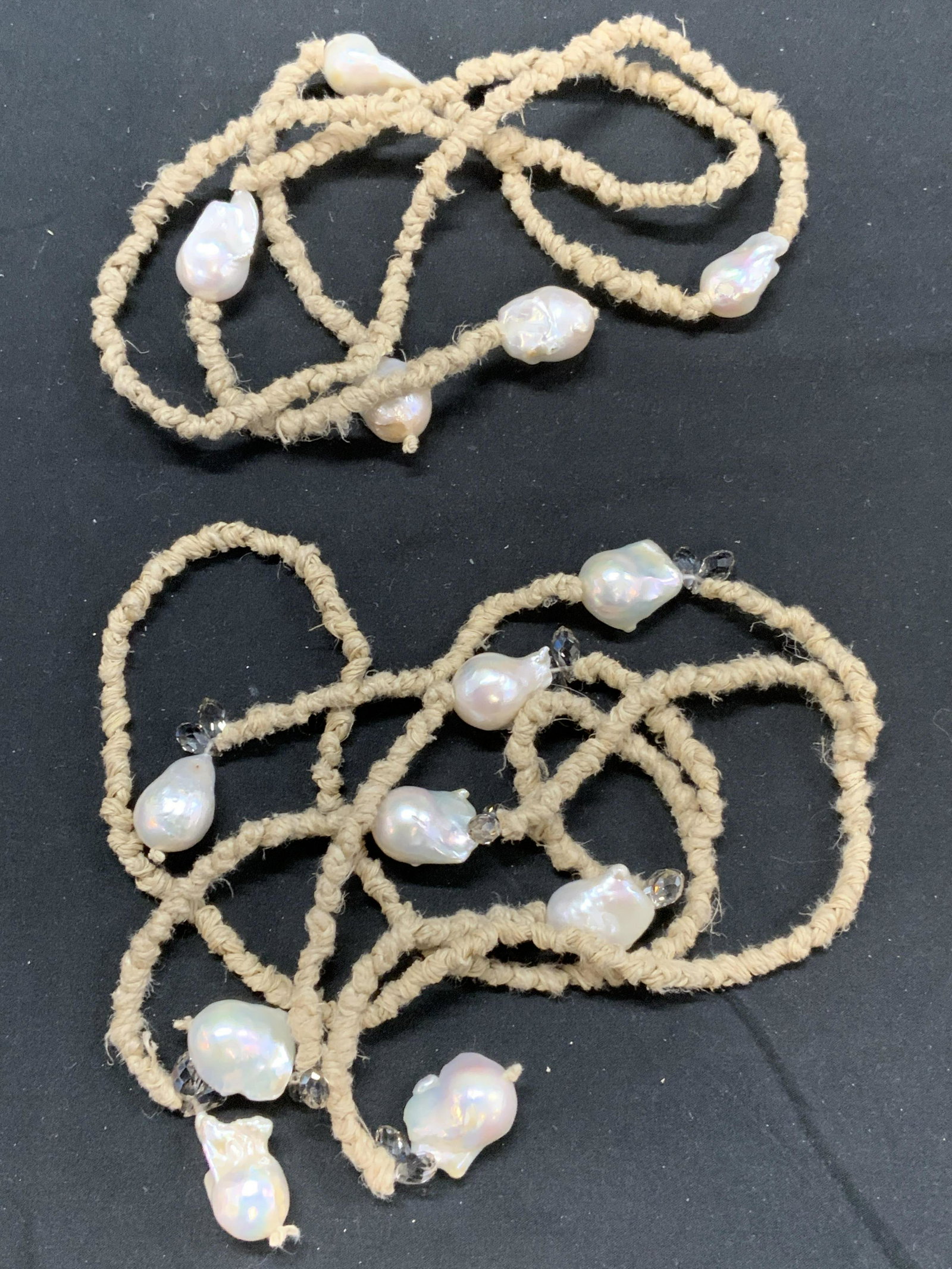 Lot 2 Baroque Pearl & Crystal Lariat Necklaces: Lot of 2 baroque Pearl lariat necklaces. One baroque Pearl necklace with faceted tear drop shaped crystals on natural fiber knotted string with double strands on both ends, measures approx. 39 inches 