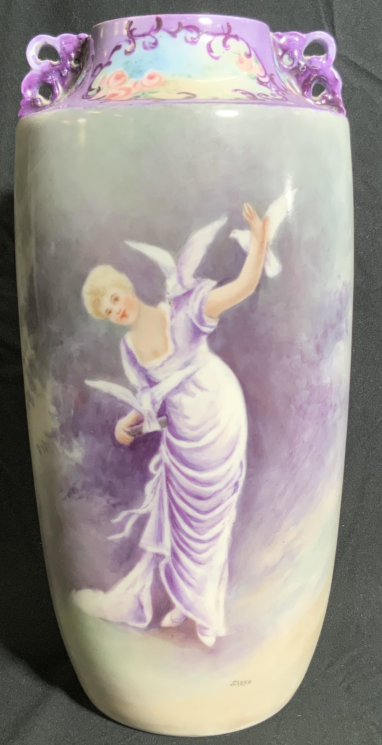 LIMOGES FRANCE Vintage Hand Painted Porcelain Vase: Vintage possibly antique. A hand painted porcelain vase depicting a woman frolicking with doves. She wears a long dress, her hair is in an updo. A signature is by her feet, reads SLOBE. Ornate handles