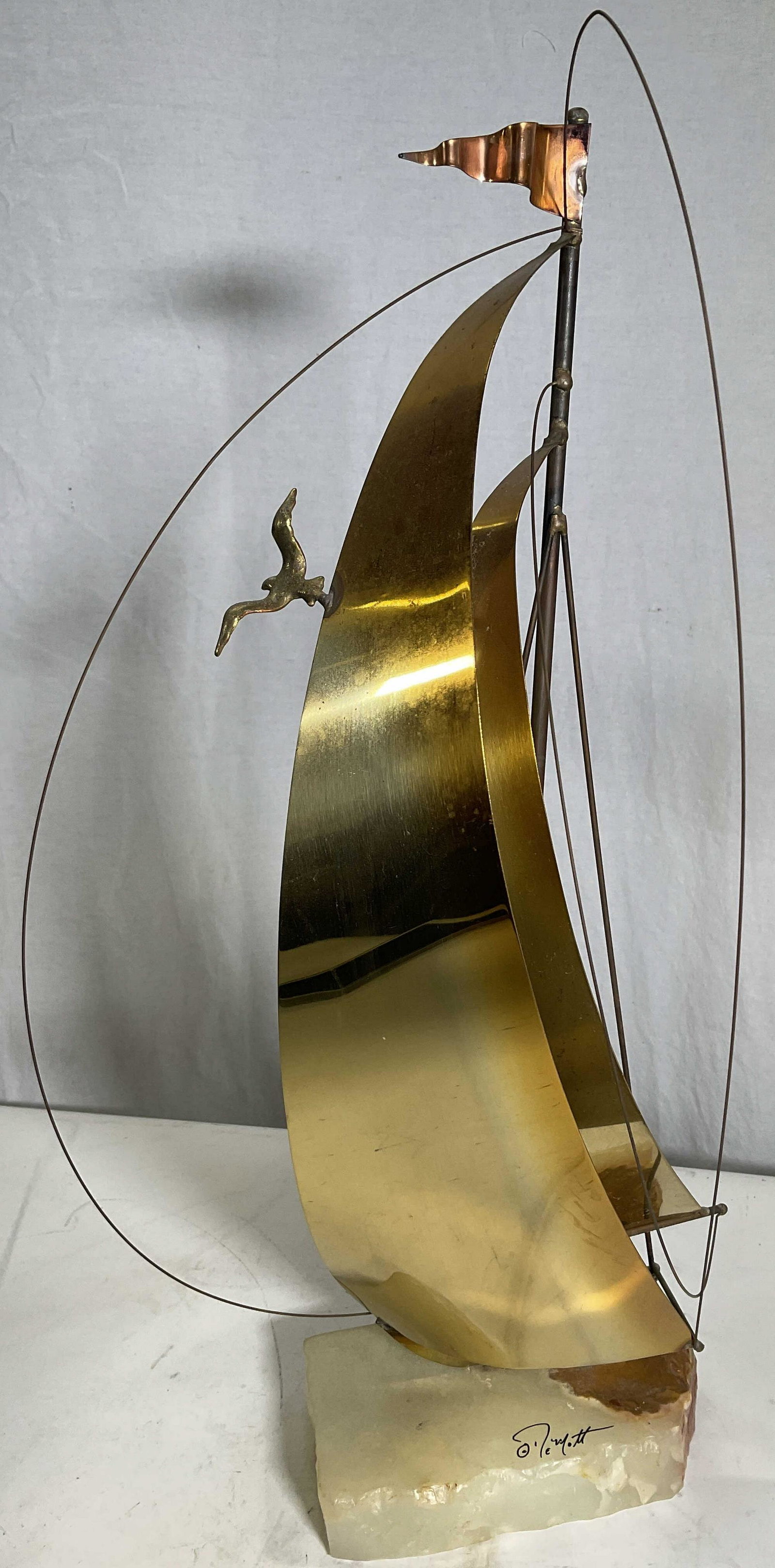 Signed DeMott Mixed Metal Onyx Sail Boat c1970s: Signed DeMott, circa 1970s American. Sailboat sculpture with natural stone base. Signed DeMott. Measures 20.5H x 10W x 7D inches. Surface wear to piece consistent with age and use. Sail boat, natural 