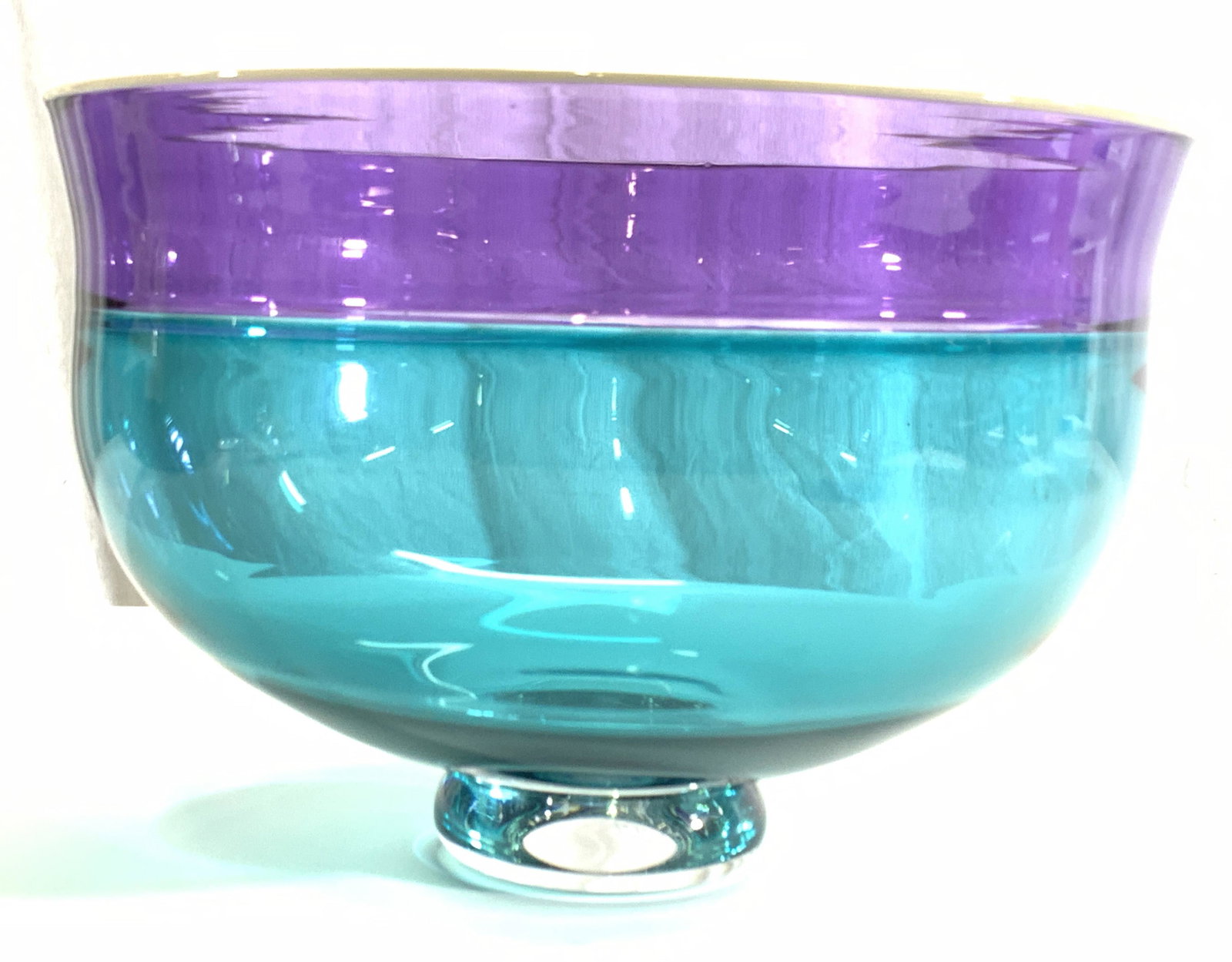 SIGNED Alex Brad Artist Crafted Crystal Bowl: A crystal made bowl, signed on underside by artist, appears to read Alex Brad. Bowl has rounded foot. Base is blue toned with purple rim band. Approximately 6.25 inches tall, and 9 inch diameter. Prop