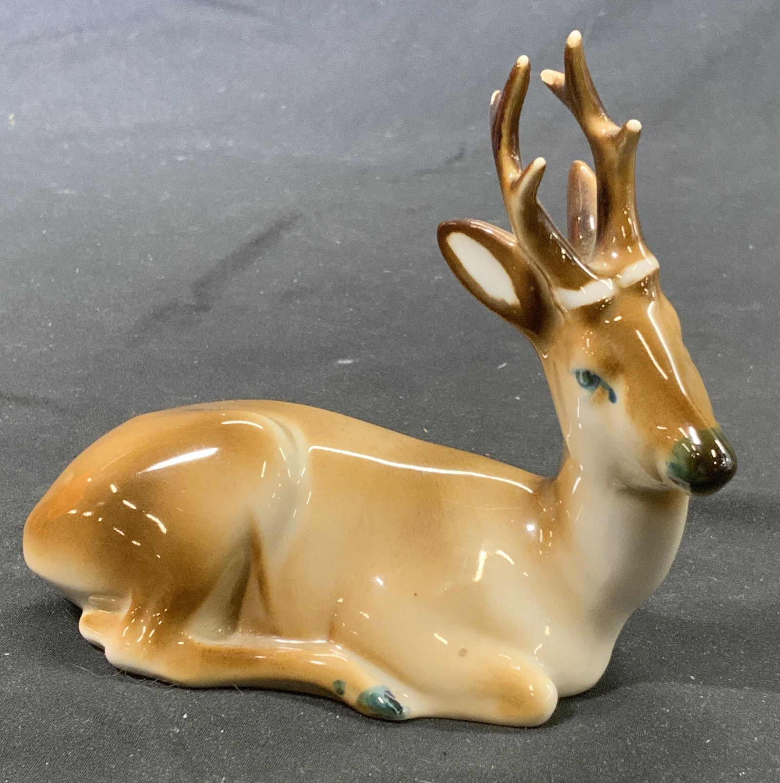 ZSOLNAY Porcelain Hand Painted Deer Figurine: Signed ZSOLNAY hand painted porcelain resting deer figurine. Made in Hungary. In good condition. Measures approx. 4.75 x 2.25 x 4.25 inches. Property of Palm Beach, Fl Estate. ZSOLNAY, ZSOLNAY figurin