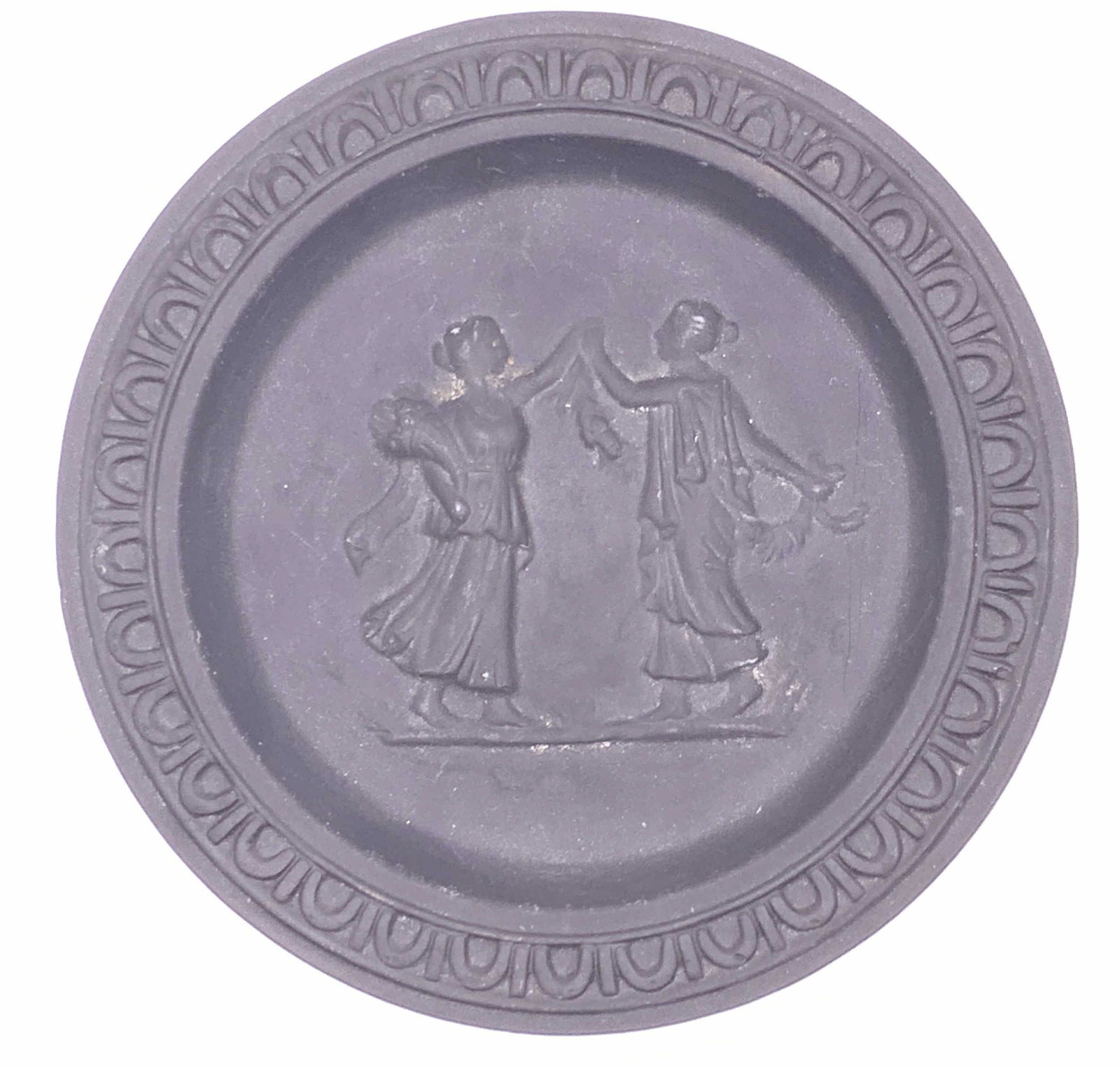 Vintage Black Basalt Figural Pin Tray: A vintage matte black basalt Jasperware pin tray with figural Greco Roman motif in center relief. Measures approx. 3 7/8 inches diameter. Surface wear consistent with age, use, and exposure. Attribute