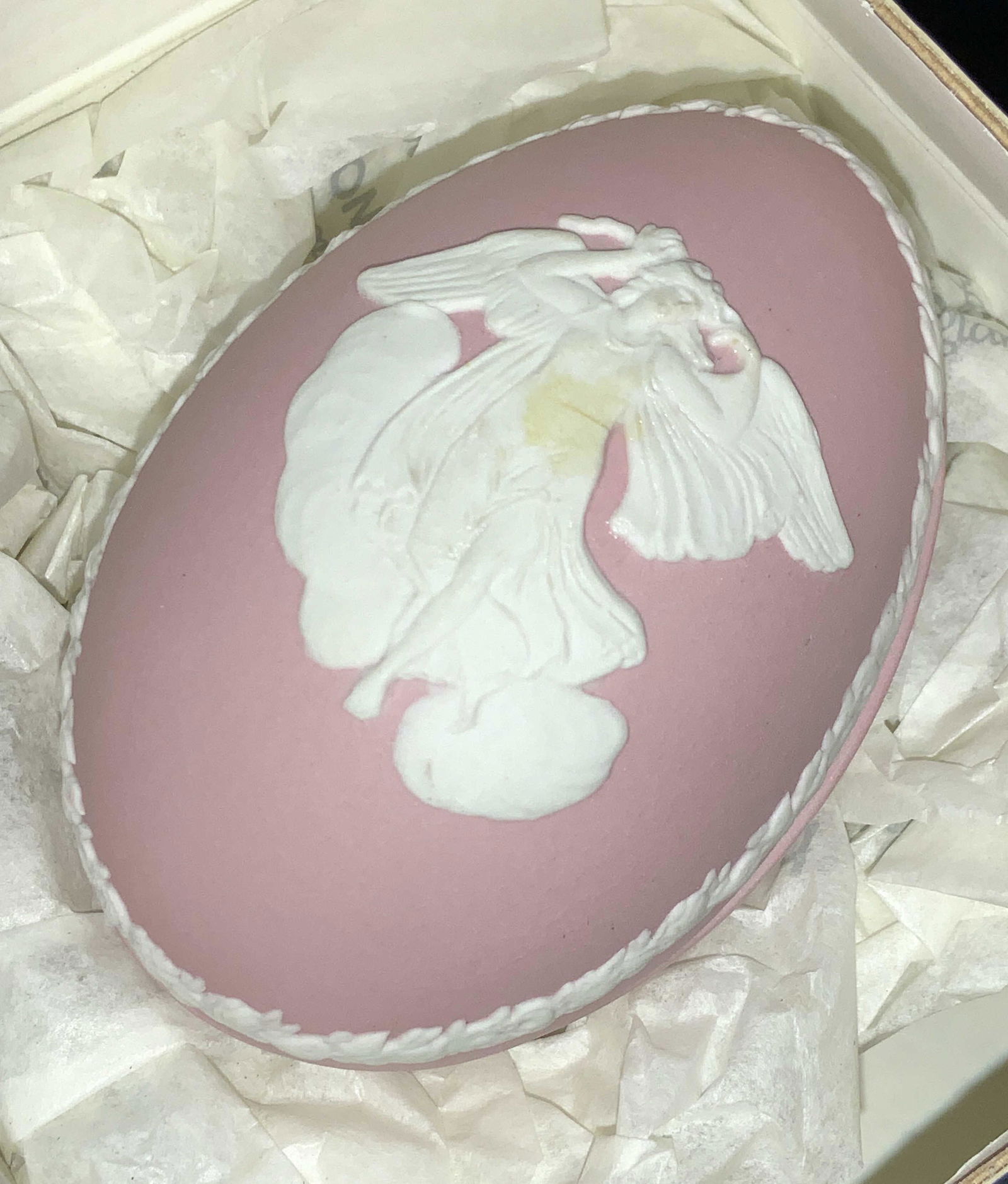 WEDGWOOD Pink Porcelain Egg Trinket Box, England: Signed Wedgwood pink porcelain egg with raised neoclassical image of female Angel. This piece is a trinket box that comes in the original Wedgwood box, wrapped in tissue paper. Egg measures 3 x 2 in.