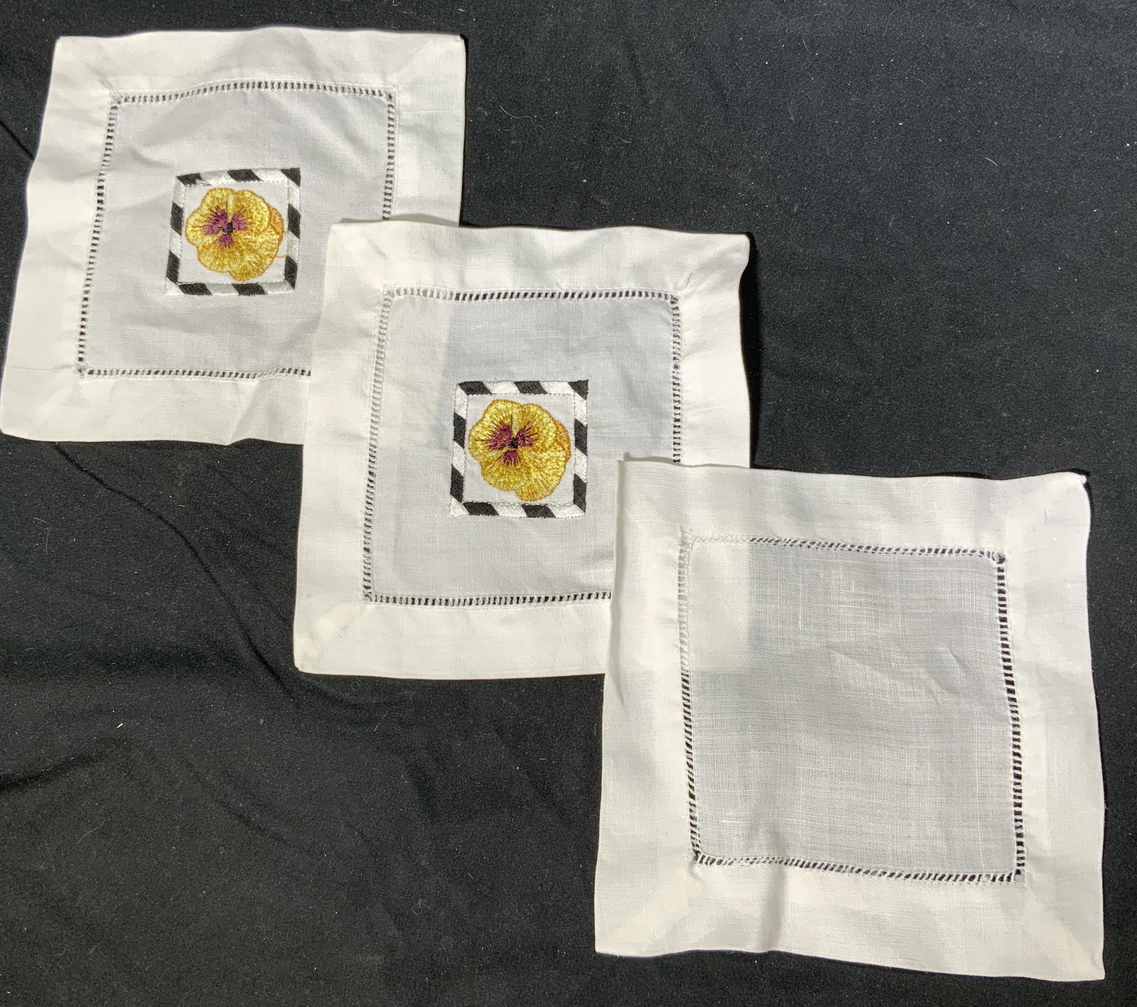 Set 3 White Floral Cloth Cocktail Napkins: Set of 3 cloth cocktail napkins, 2 with yellow floral motif and 1 plain white. Measure approx. 6 x 6 inches each. In good condition. Property of Palm Beach, Fl Estate. Cocktail napkins, cloth napkins,