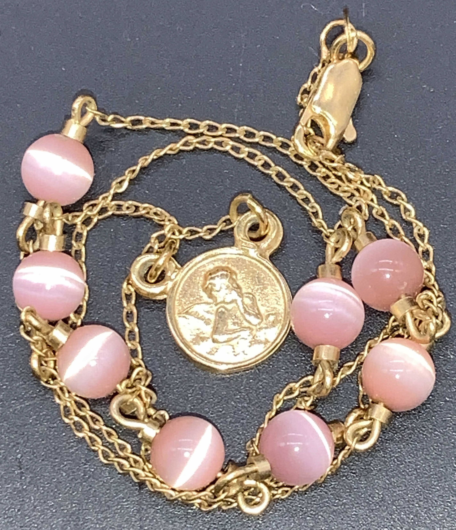 18k Gold Filled Choker with Cherub Pendant: Station bead necklace with center cherub pendant. Chain is marked 18K gold filled near clasp. Dainty pink stationary beads and yellow gold cable chain, 17 in. Long. Property of Palm Beach, FL estate c