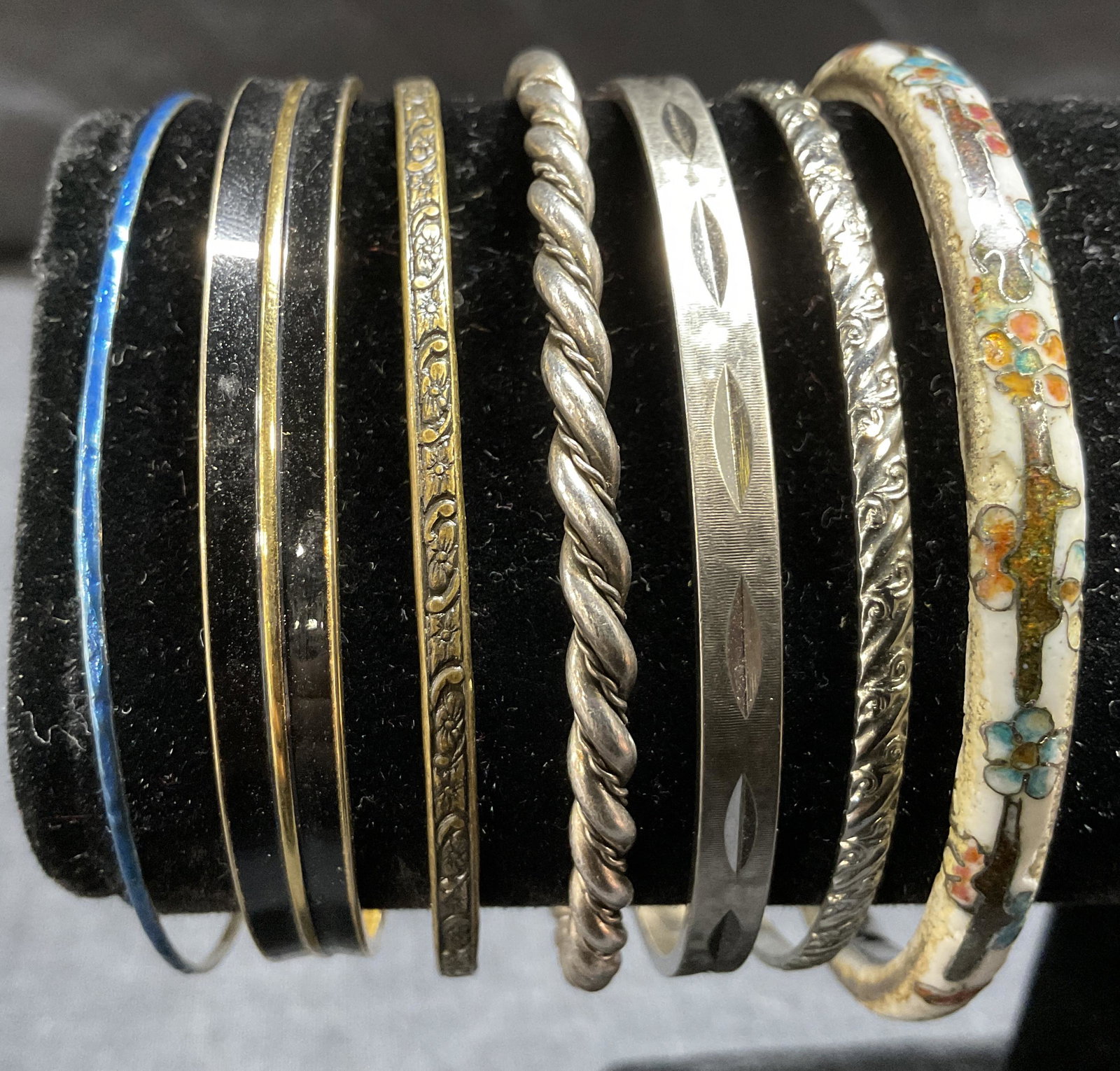 Lot 7 Metal & Ceramic Bangles: Lot 7 Metal & Ceramic Bangles, inscriptions to black and gold toned bangle reads Monet, all measure approximately 2 5/8 - 2 3/4 inches in diameter, surface wear to pieces, Property of Palm Beach Estat