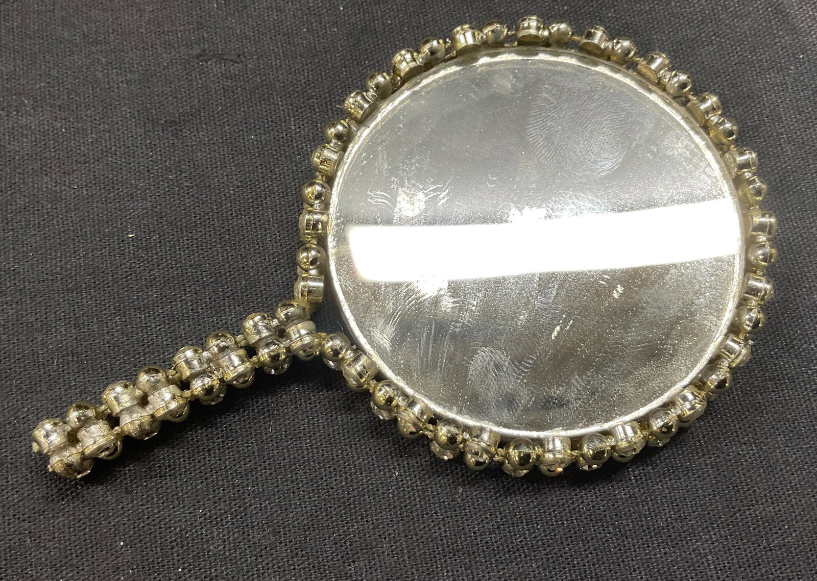 Miniature Rhinestoned Vanity Mirror: Miniature Rhinestoned Vanity Mirror, no apparent inscriptions or markings to piece, measures 3 7/8 x 2 1/2 inches in diameter, surface wear to piece, Vanity mirror, pocket mirror, miniature mirror, wo