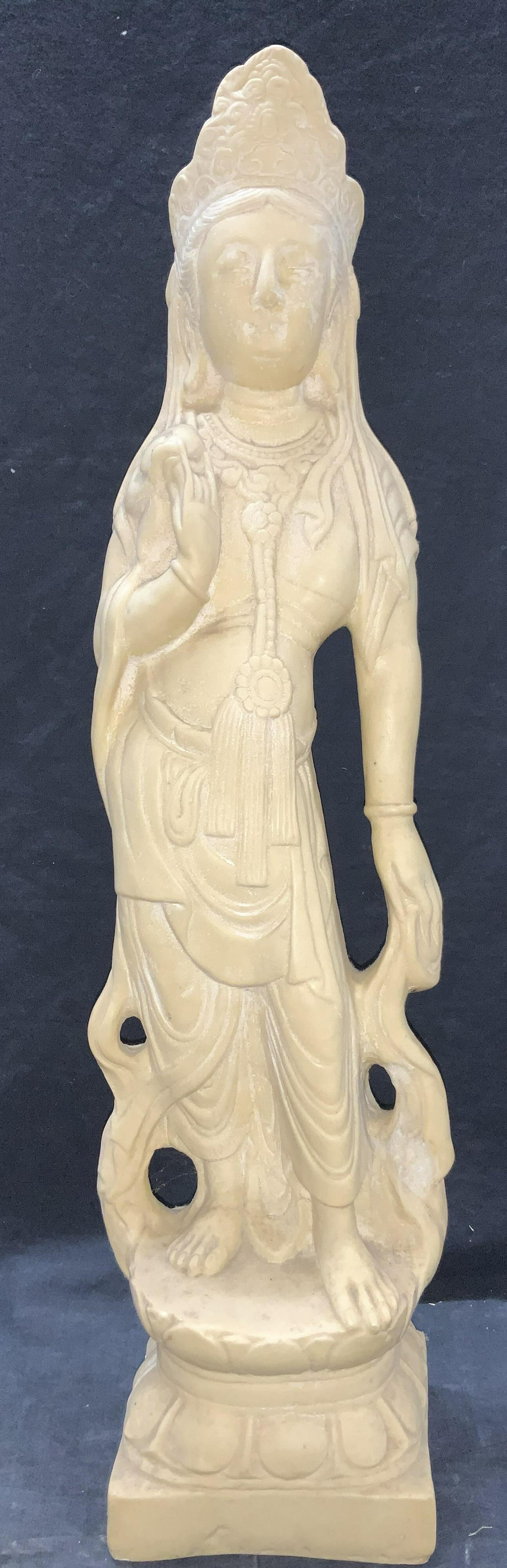 27 Inch Tall Female Deity Sculpture: A heavy weight, natural stone 27 inch tall floor sculpture of a female Hindu or Buddhist deity. Depicting a bare chested woman with a headdress, robes that drape down from her waist and shoulders. App