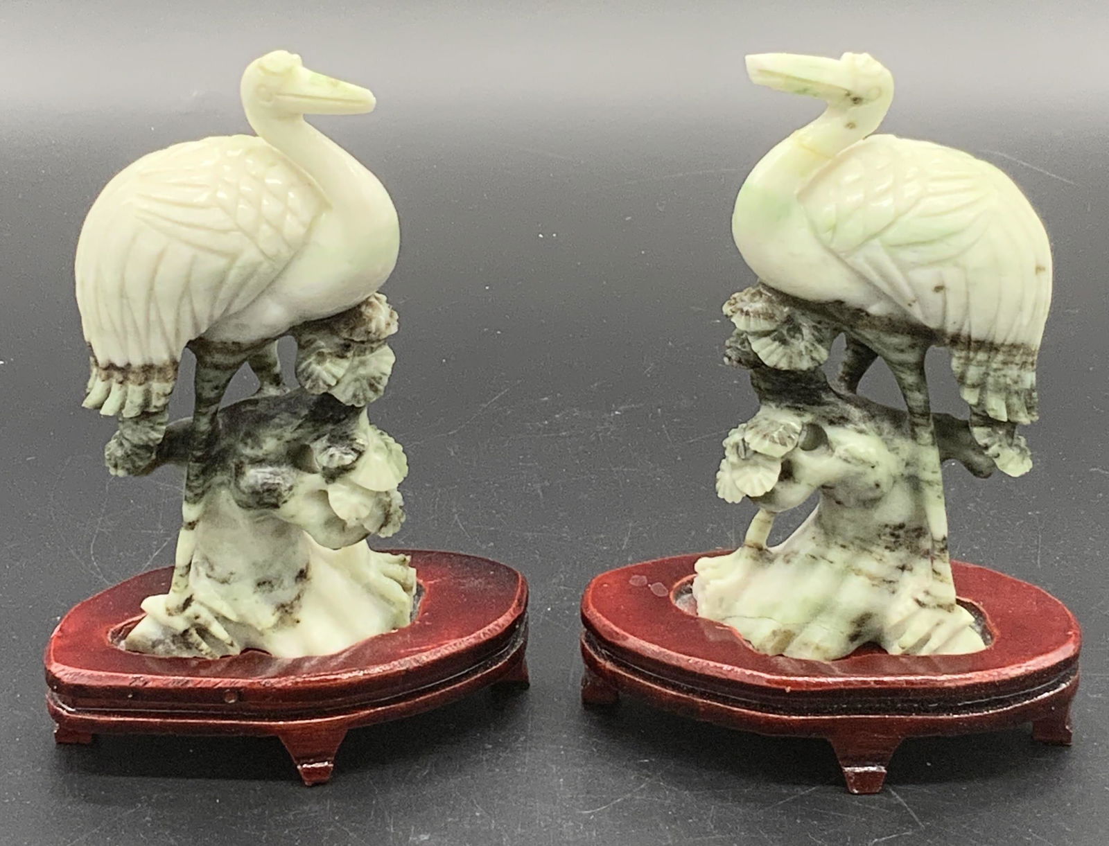 Box Set Of Natural Stone Cranes With Pedestals: Box Set Of Natural Stone Cranes With Pedestals, upholstered box with three sections, includes green banded natural stone cranes and separate carved red wood pedestals, versos numbered 64. Cranes with