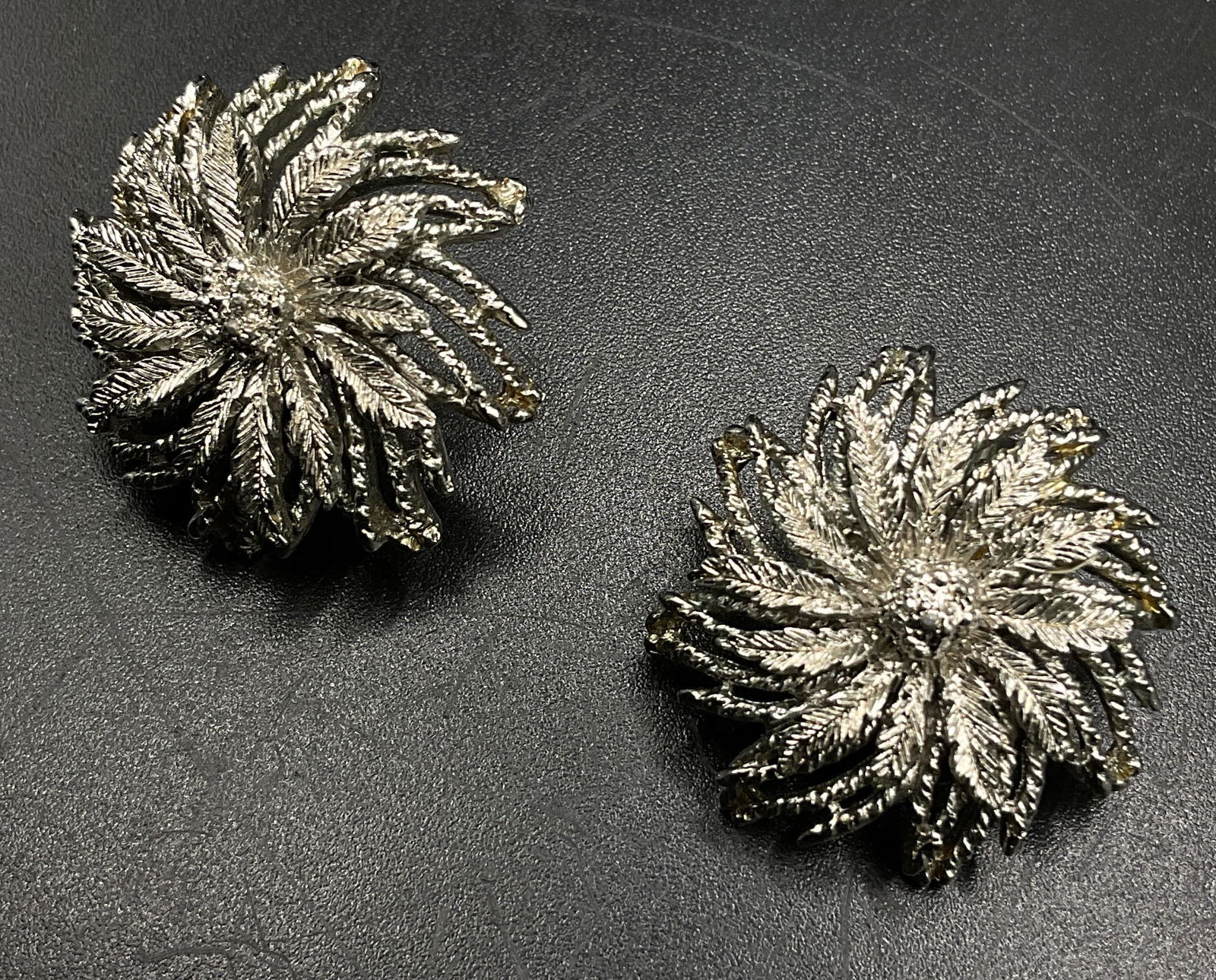 Signed Monet Clasp Earrings: Signed to back of earrings monet. Silver toned floral shaped earrings. Measures approx 1 inch. Some wear to pieces. Clasp earring, clip on earring, signed monet, floral shaped earrings, womens wear, c