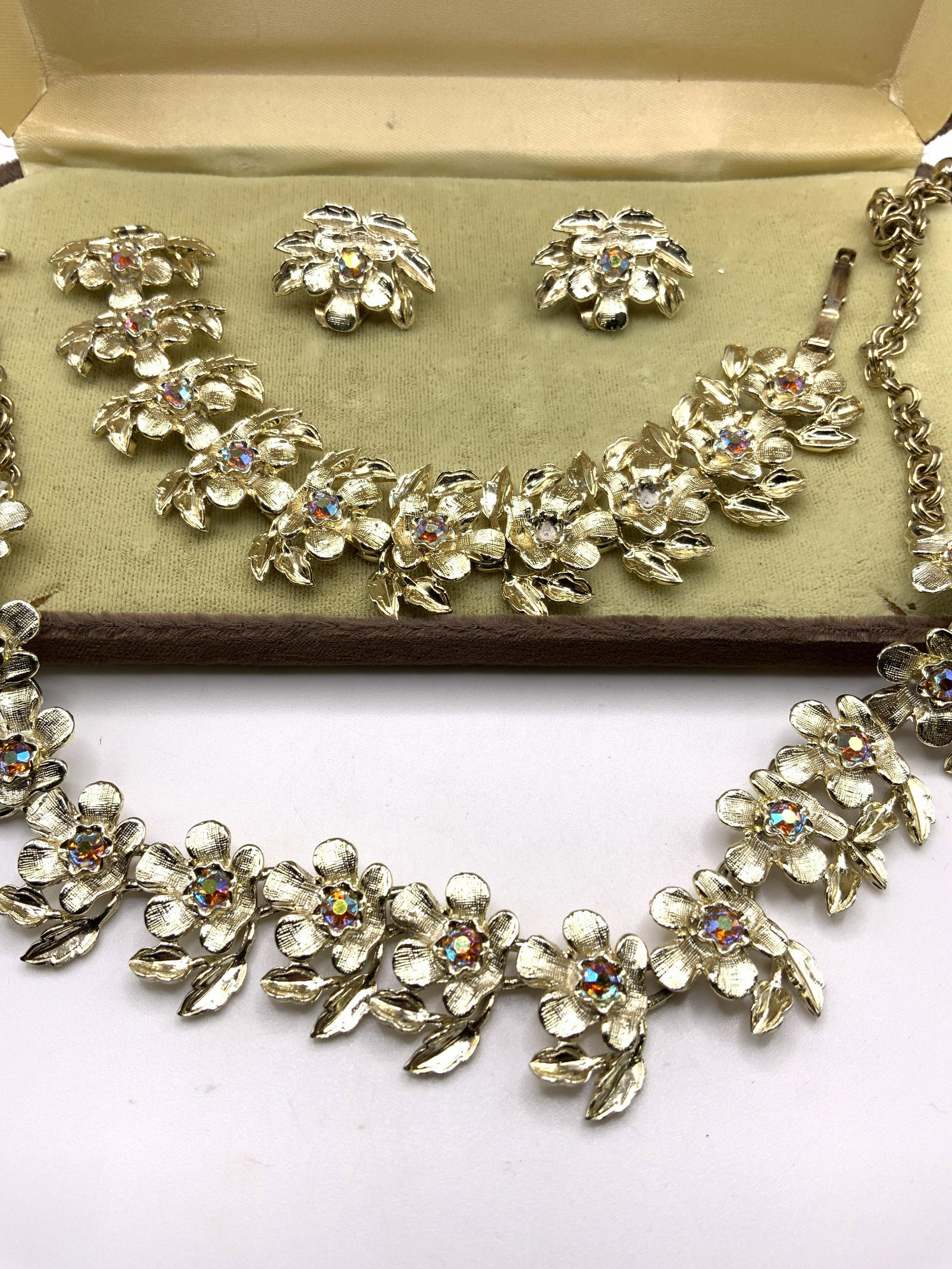 Group JUDY LEE Signed Jewelry Set Circa 1950s: Set of Vintage Signed Judy Lee Jewelry pieces. All pieces in the same style, gold tone embossed metal with floral motif and faceted bezel set iridescent crystals. Signed JUDY LEE on necklace clasp, br
